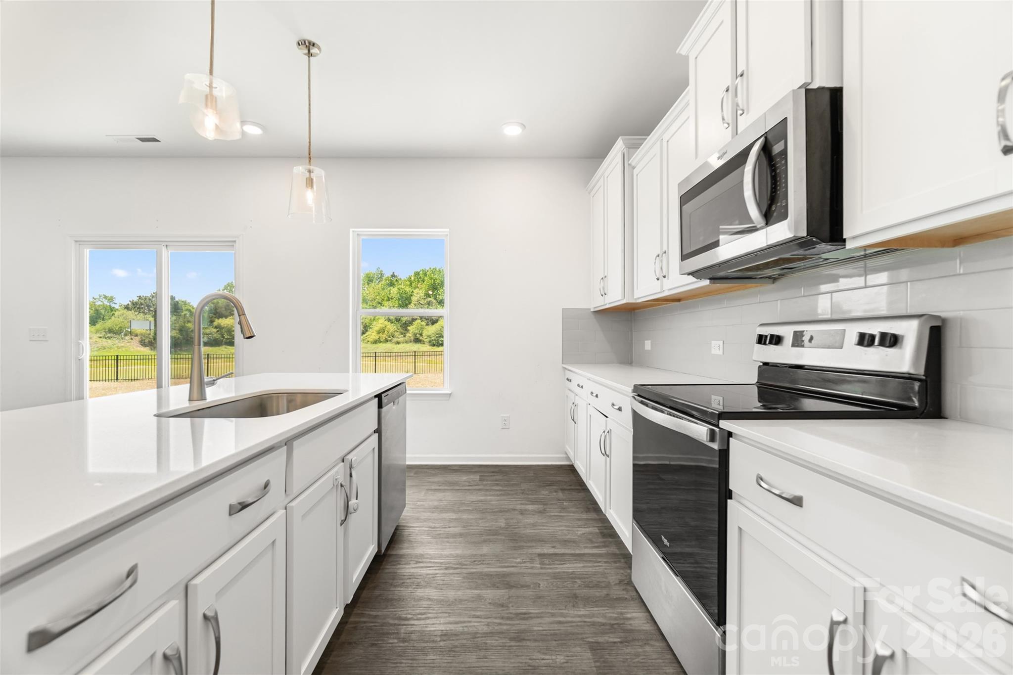 108 Aspire Circle Wingate, NC 28174 - Photo 13 of 31 a kitchen with stainless steel appliances granite countertop a sink and dishwasher a stove top oven with wooden floor