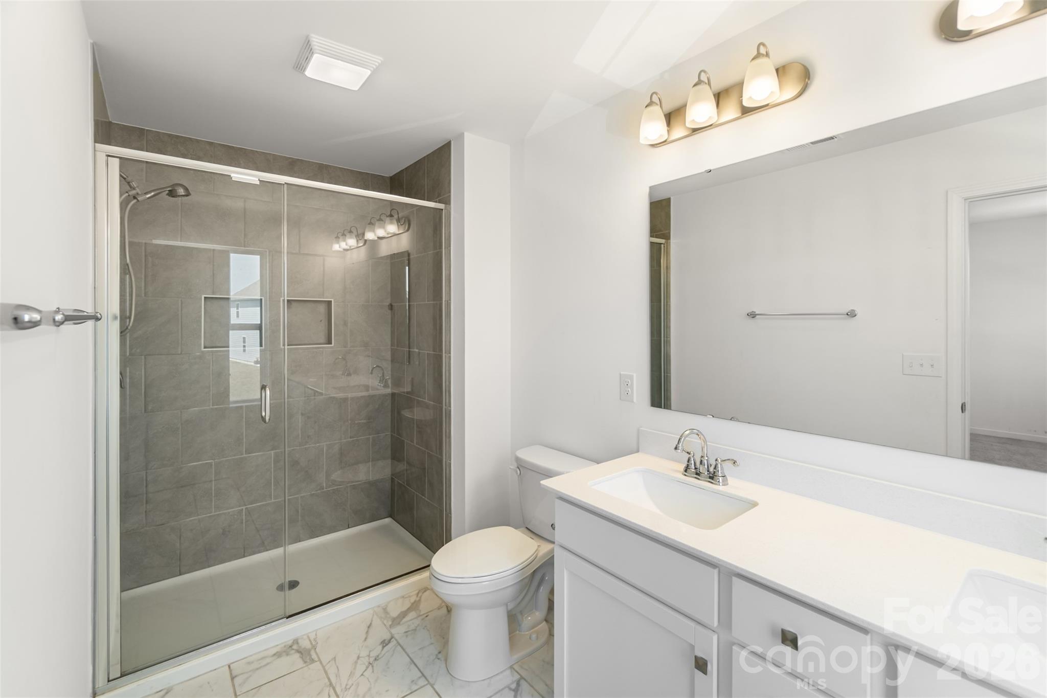 108 Aspire Circle Wingate, NC 28174 - Photo 20 of 31 a bathroom with a sink shower and a toilet