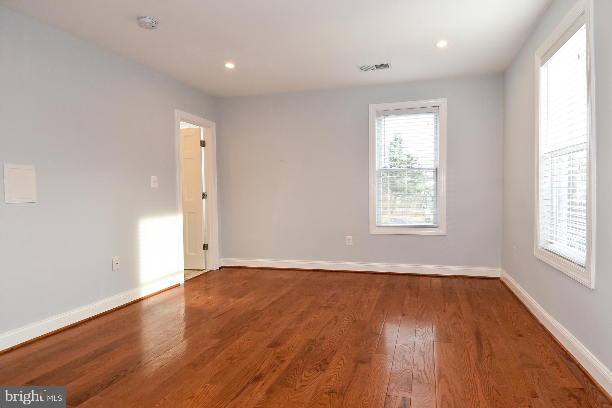 1117 Montello Avenue Northeast Washington, DC 20002 - Photo 16 of 64 an empty room with wooden floor and windows