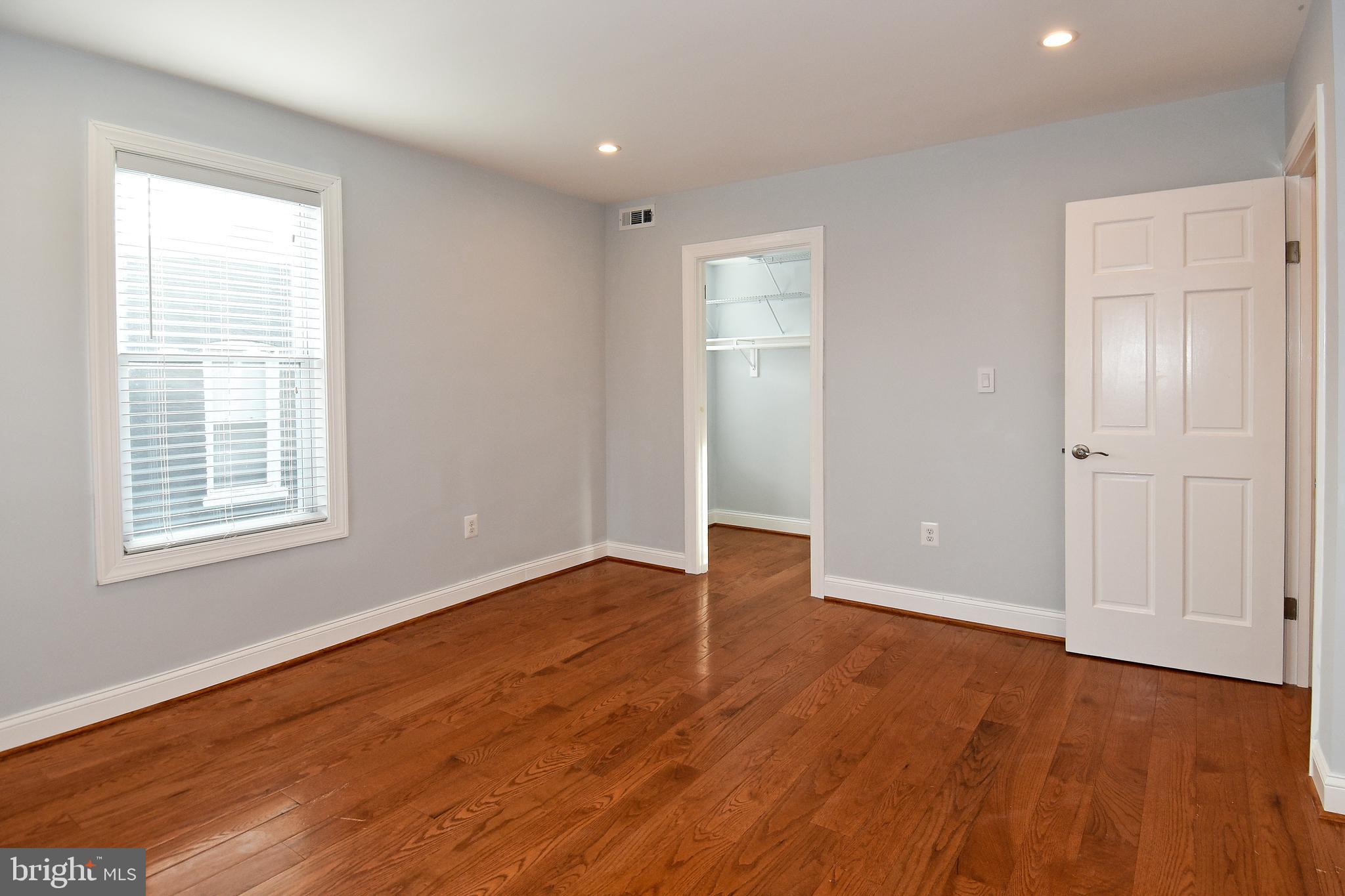 1117 Montello Avenue Northeast Washington, DC 20002 - Photo 17 of 64 an empty room with wooden floor and windows