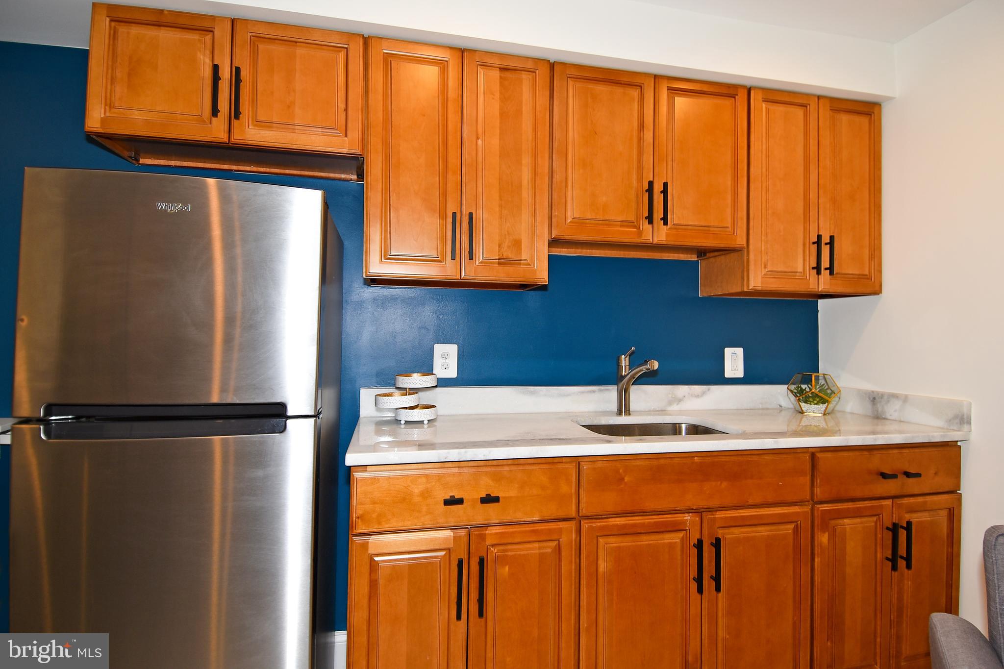 1117 Montello Avenue Northeast Washington, DC 20002 - Photo 36 of 64 a kitchen with stainless steel appliances granite countertop a refrigerator and a sink