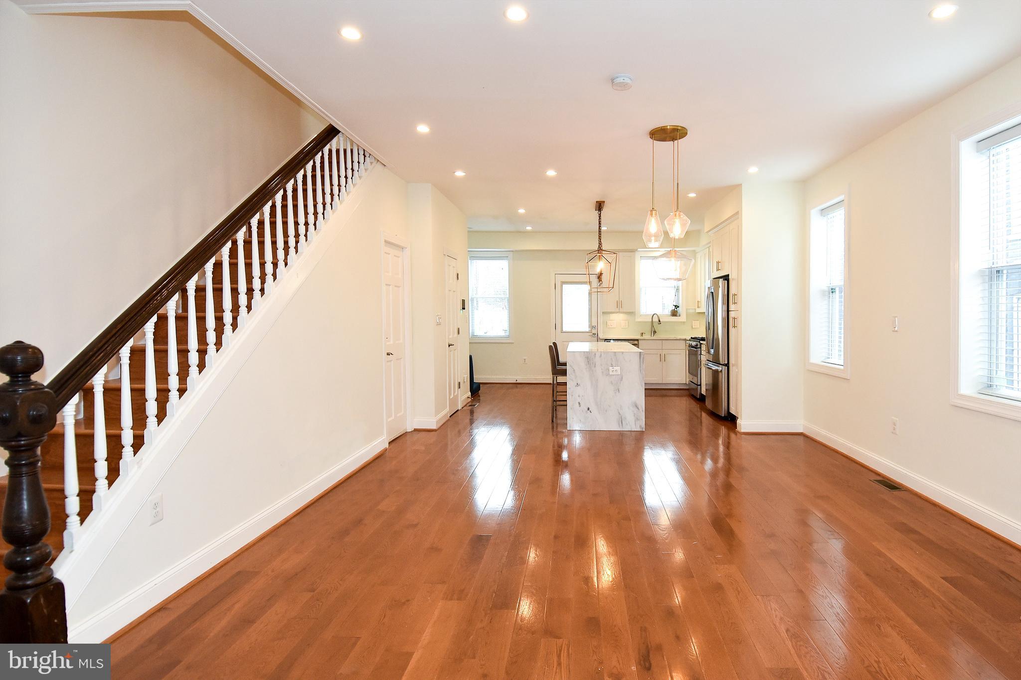 1117 Montello Avenue Northeast Washington, DC 20002 - Photo 6 of 64 a view of a living room with wooden floor and a kitchen