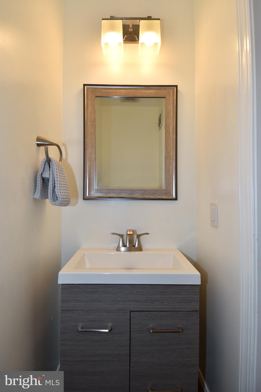 1117 Montello Avenue Northeast Washington, DC 20002 - Photo 8 of 64 a bathroom with a sink and a mirror