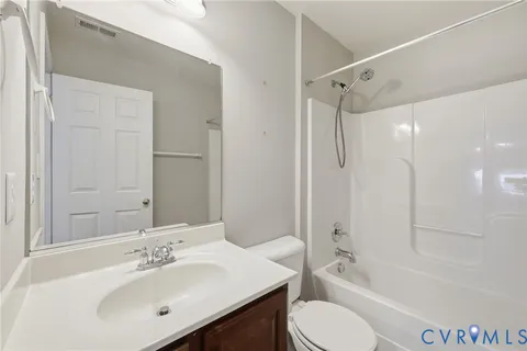 a bathroom with a bathtub a window and a shower