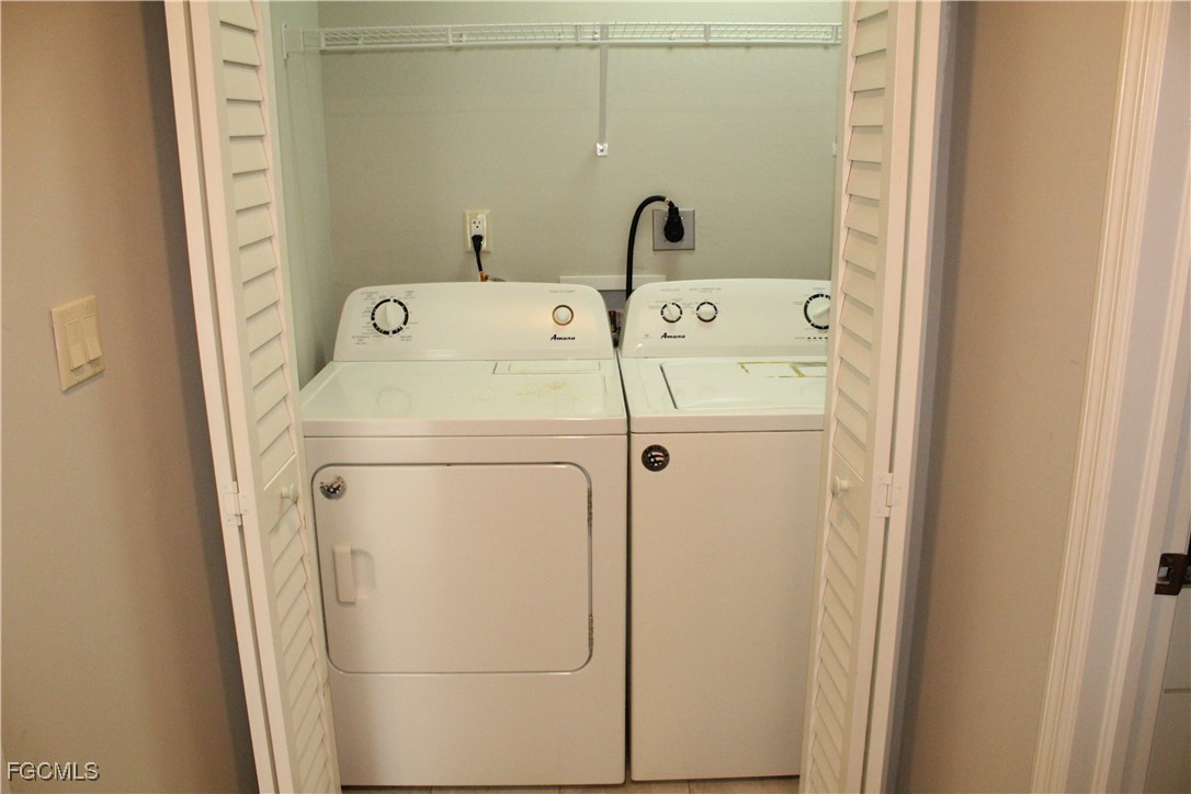 1110 Southwest 47th Terrace, Unit 102 Cape Coral, FL 33914 - Photo 13 of 13 a utility room with dryer and washer