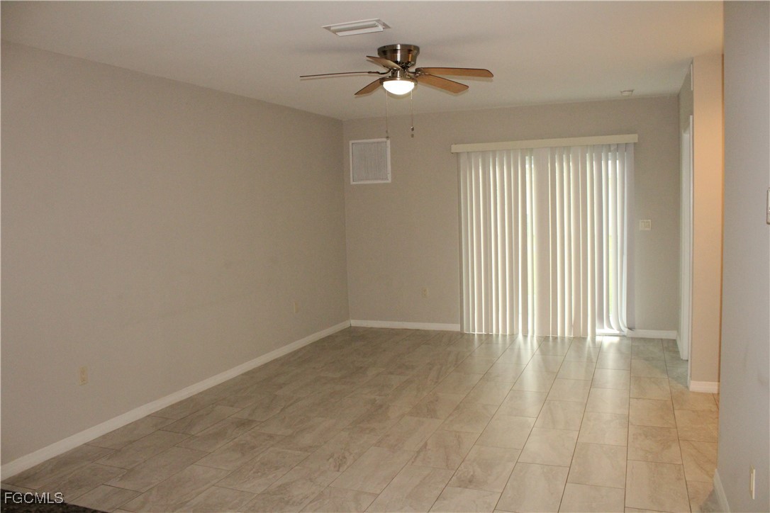 1110 Southwest 47th Terrace, Unit 102 Cape Coral, FL 33914 - Photo 5 of 13 wooden floor in an empty room with a window