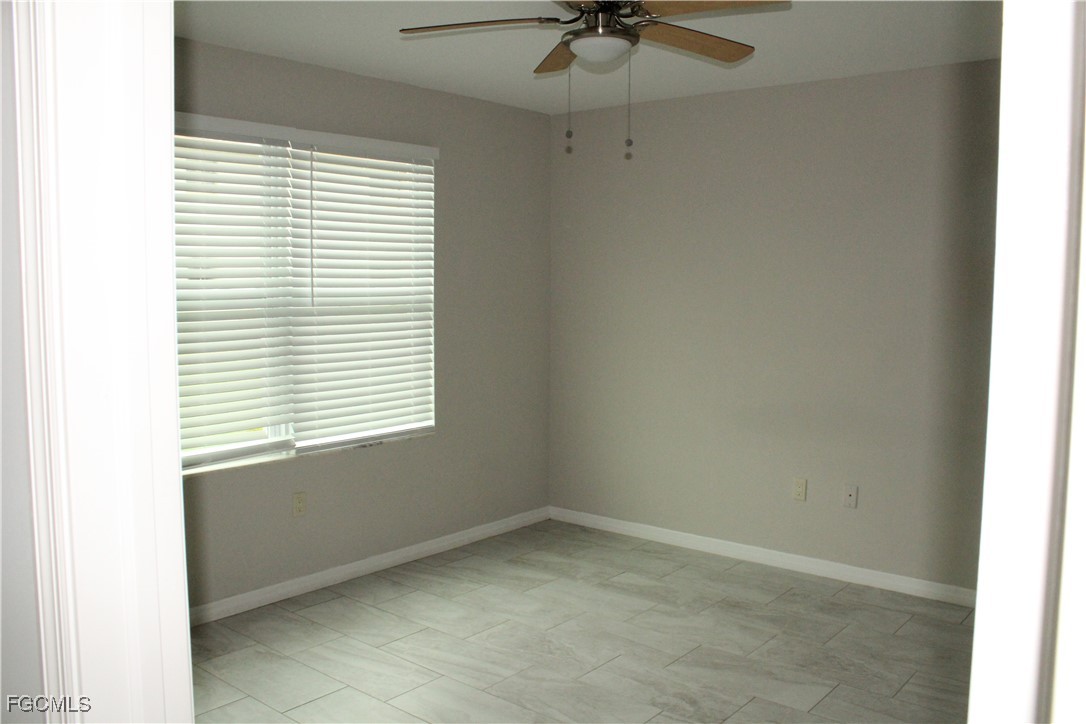 1110 Southwest 47th Terrace, Unit 102 Cape Coral, FL 33914 - Photo 6 of 13 a view of an empty room with a window