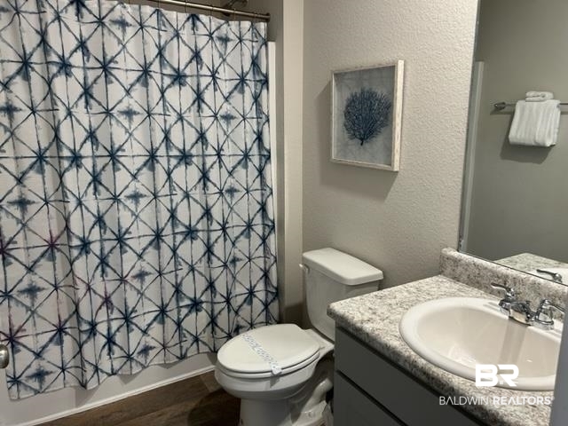 7409 Brompton Drive Foley, AL 36535 - Photo 17 of 18 Full bathroom with vanity, toilet, shower / tub combo with curtain, and hardwood / wood-style floors
