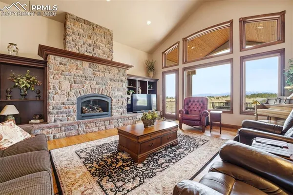 a kitchen with stainless steel appliances granite countertop a stove a sink dishwasher and a refrigerator with wooden floor
