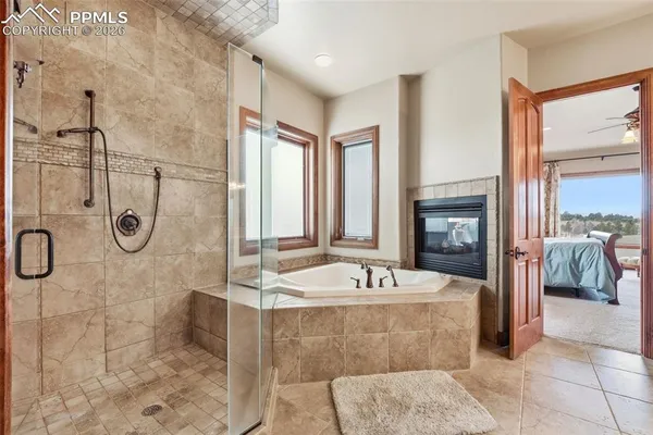 a bathroom with a granite countertop double vanity sink and a mirror
