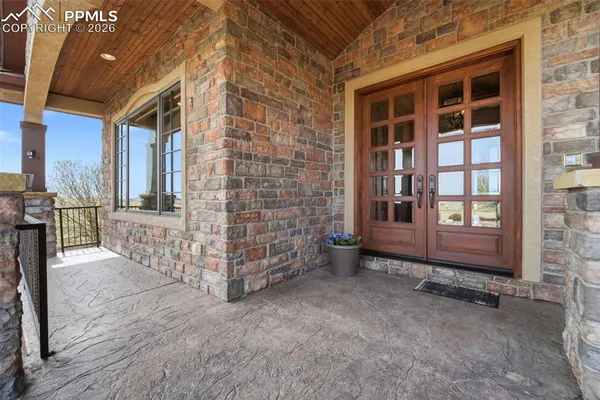 a living room with furniture fireplace and a large window