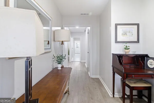 a view of hallway with furniture and wooden floor