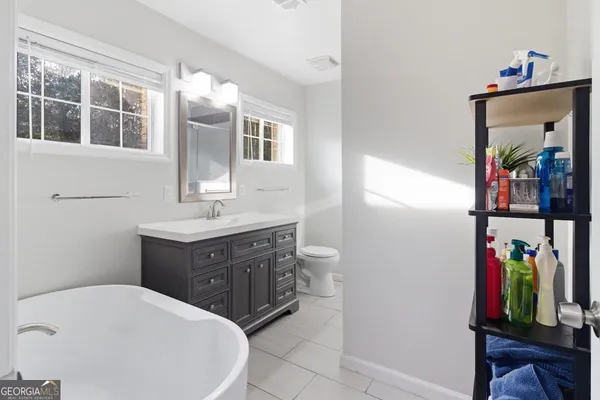 a bathroom with a sink vanity and a mirror