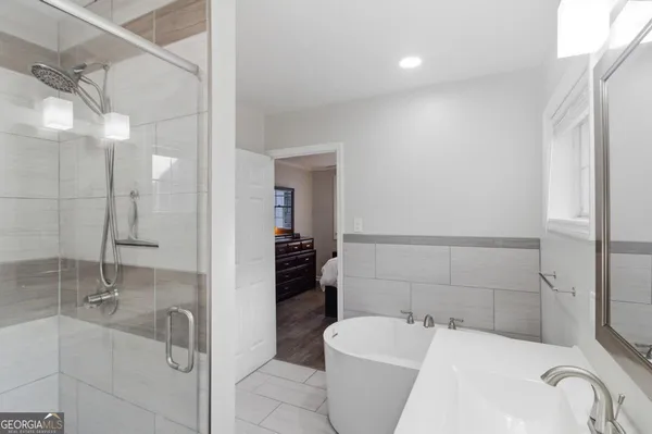 a bathroom with a bathtub and shower
