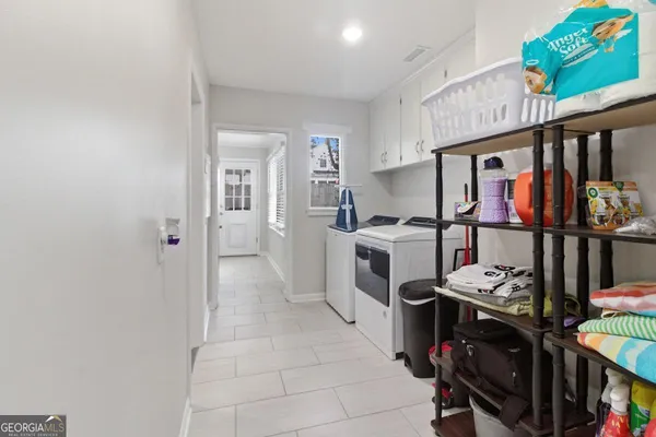 a view of a kitchen with fridge and workspace