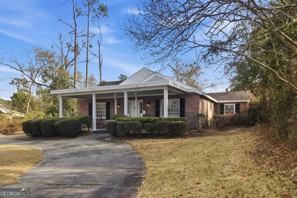 a front view of a house with garden