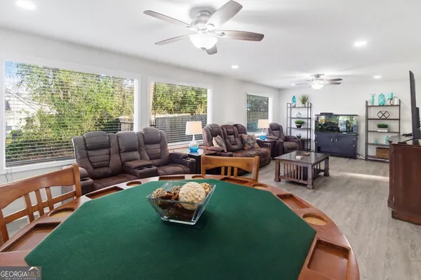 a living room with furniture a table and a large window