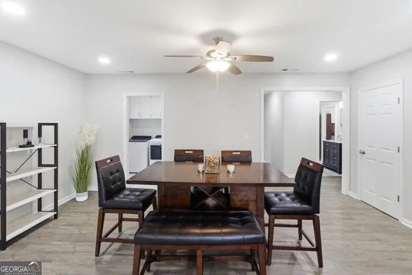 a view of a dining room with furniture and wooden floor