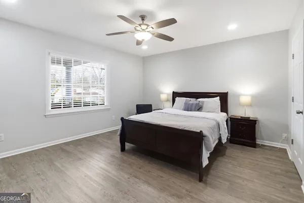 a bedroom with a large bed and a ceiling fan