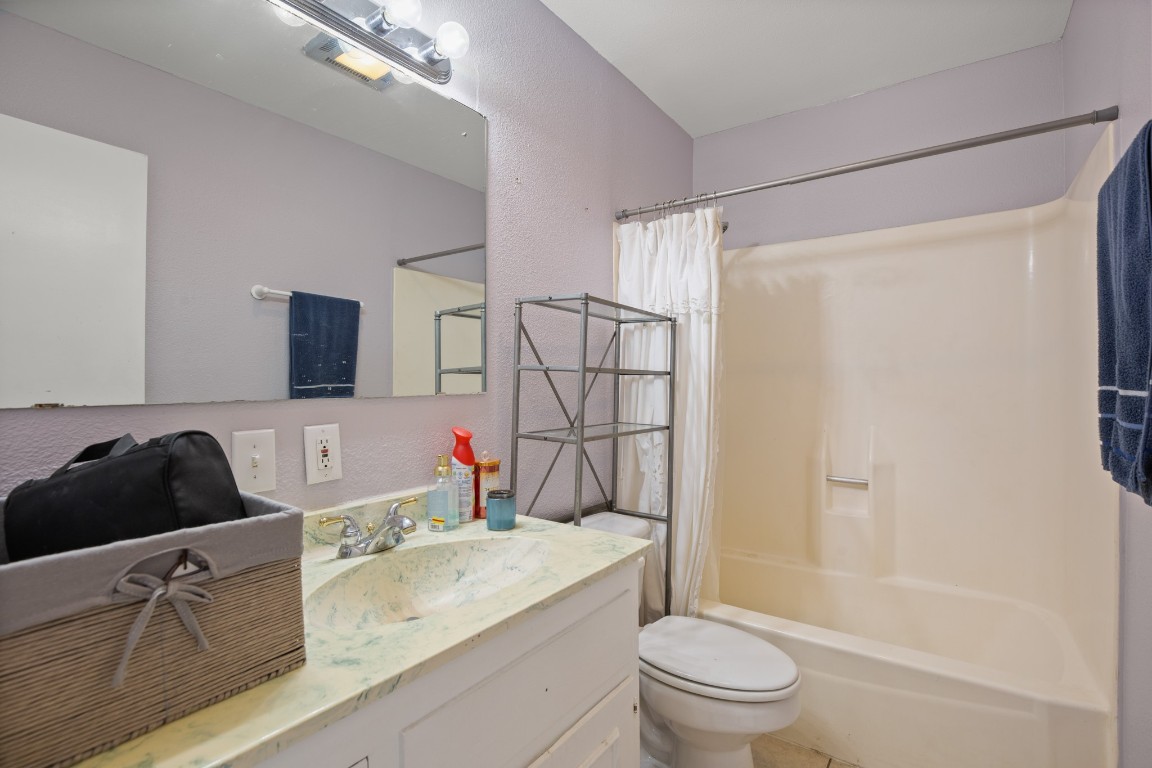 101 Homestead Road Kyle, TX 78640 - Photo 13 of 29 a bathroom with a granite countertop sink toilet and shower