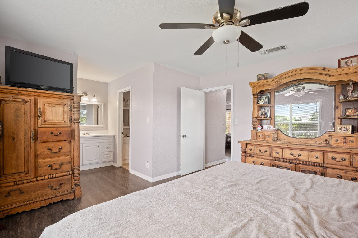 101 Homestead Road Kyle, TX 78640 - Photo 15 of 29 a spacious bedroom with a bed and a flat screen tv