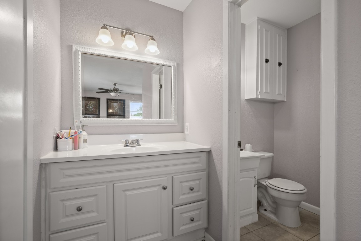 101 Homestead Road Kyle, TX 78640 - Photo 16 of 29 a bathroom with a toilet sink and mirror