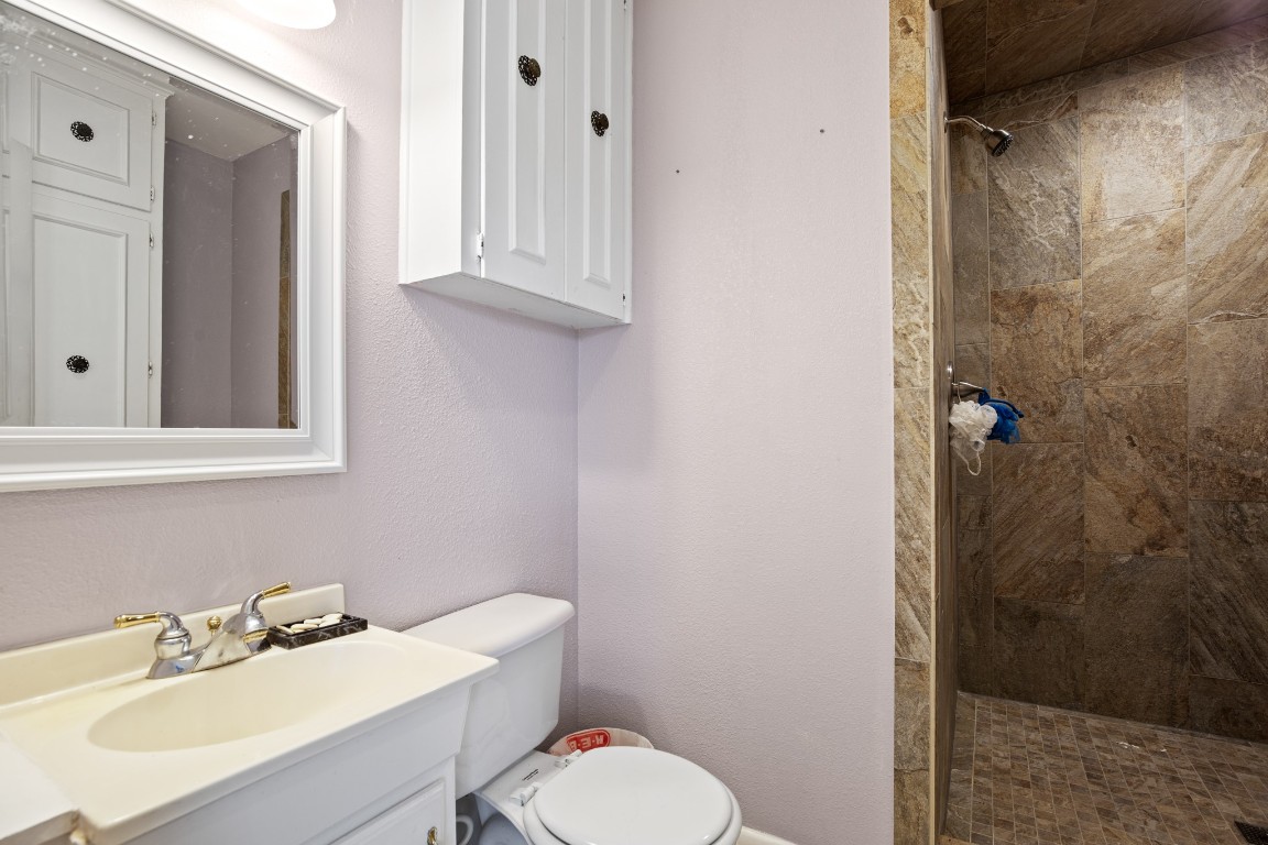 101 Homestead Road Kyle, TX 78640 - Photo 17 of 29 a bathroom with a sink mirror and toilet