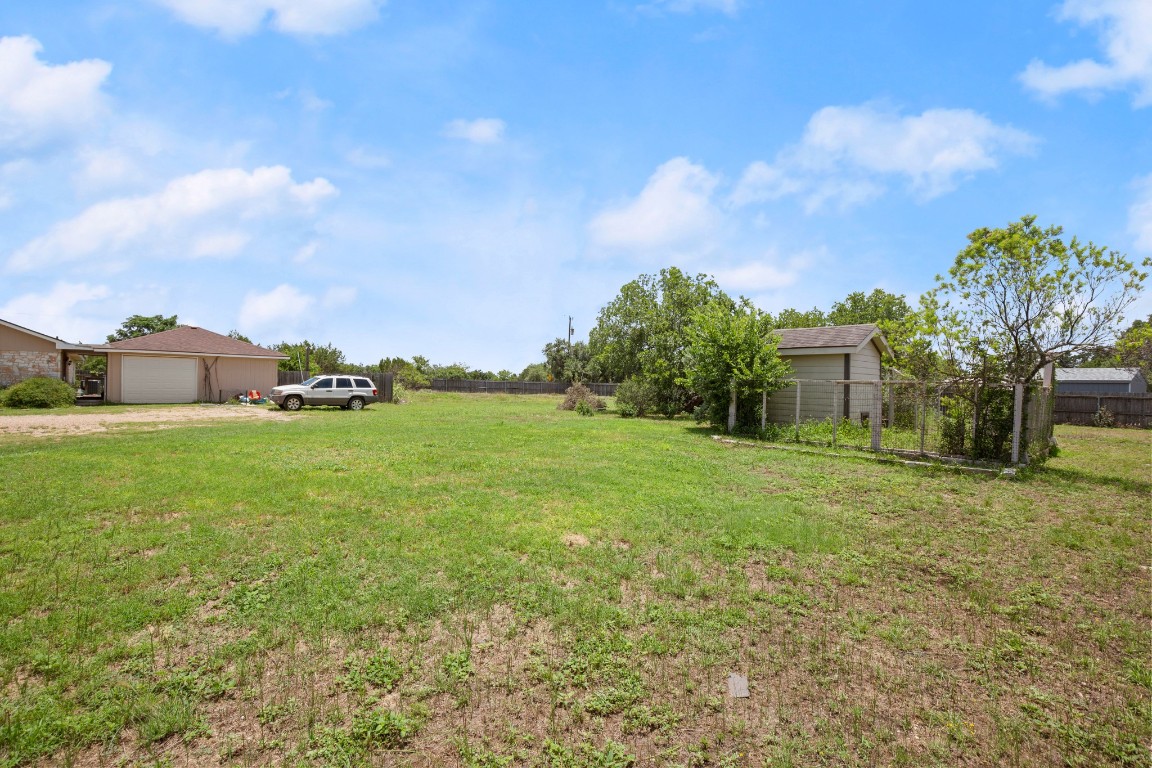 101 Homestead Road Kyle, TX 78640 - Photo 25 of 29 a view of a house with a back yard
