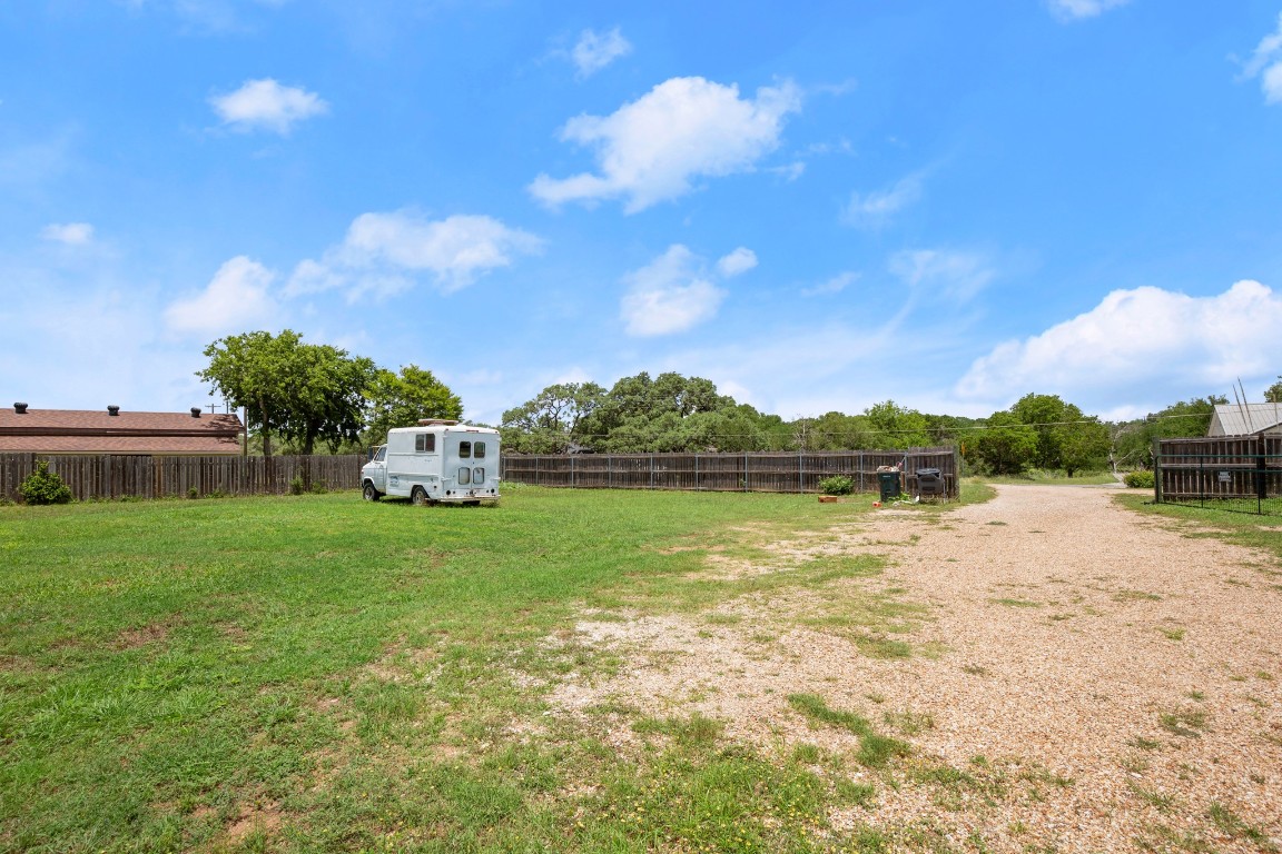 101 Homestead Road Kyle, TX 78640 - Photo 28 of 29 a backyard of a house with a yard and lake