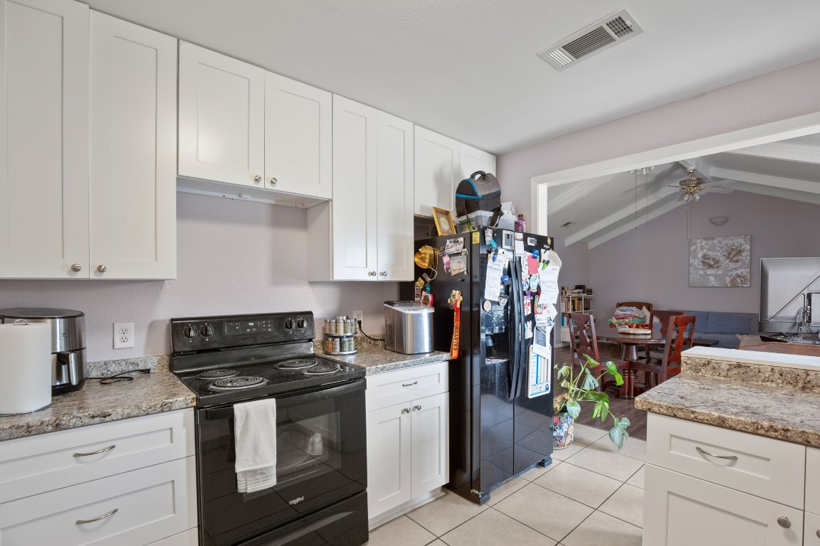 101 Homestead Road Kyle, TX 78640 - Photo 7 of 29 a kitchen with a stove and cabinets