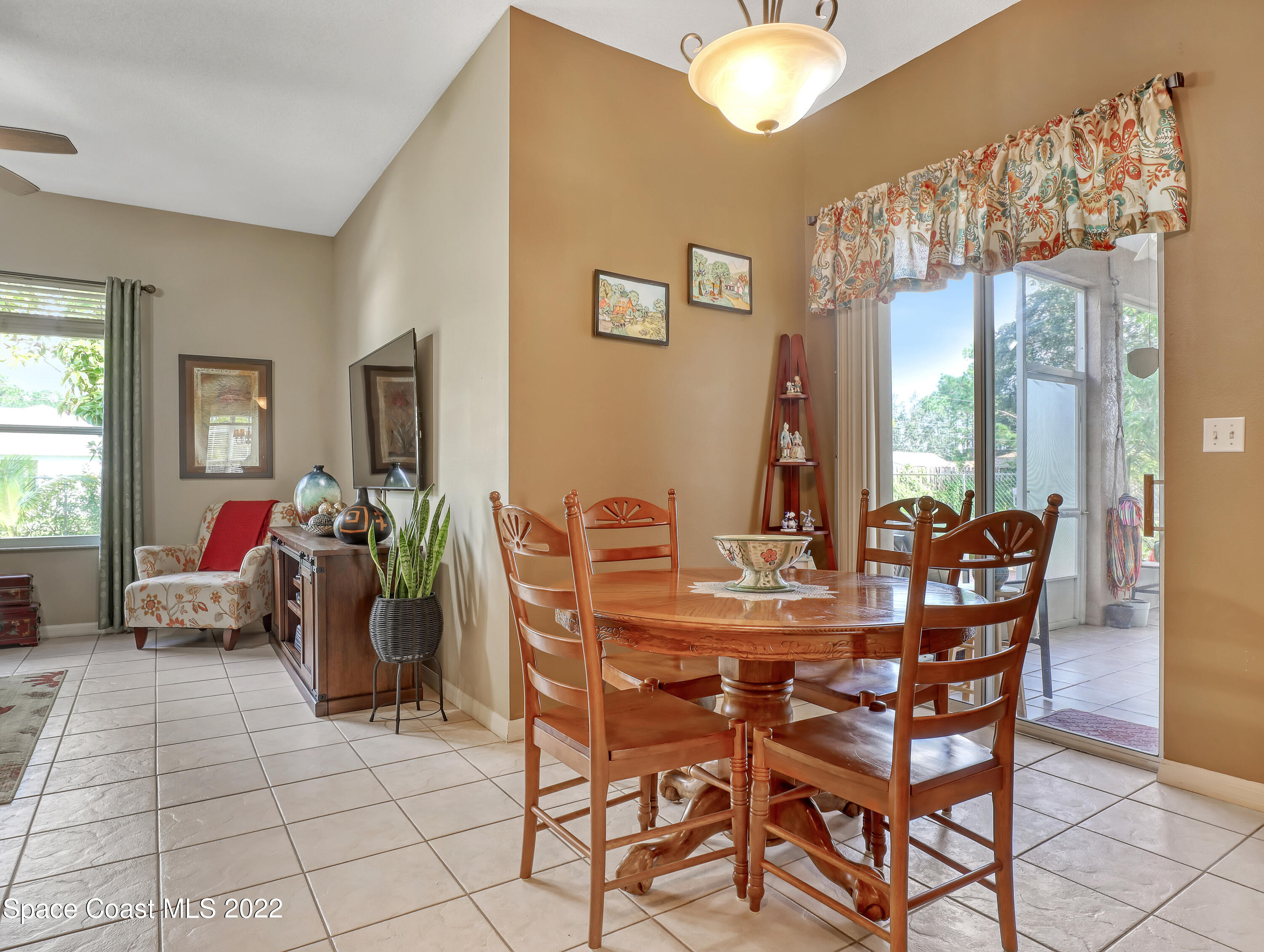 755 Raleigh Road Southeast Palm Bay, FL 32909 - Photo 11 of 36 a view of a dining room with furniture and chandelier