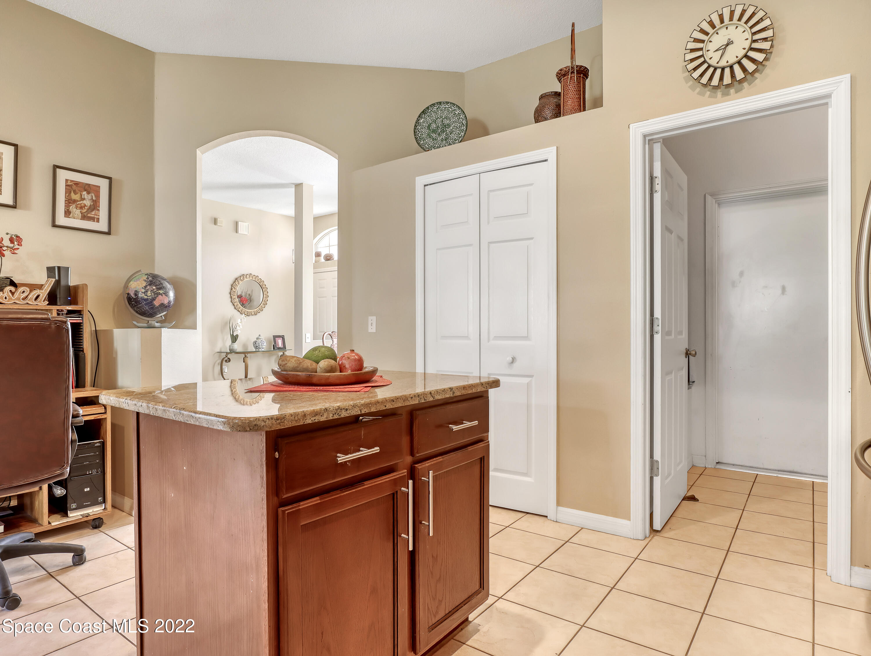 755 Raleigh Road Southeast Palm Bay, FL 32909 - Photo 13 of 36 a spacious bathroom with a granite countertop sink a mirror and a
