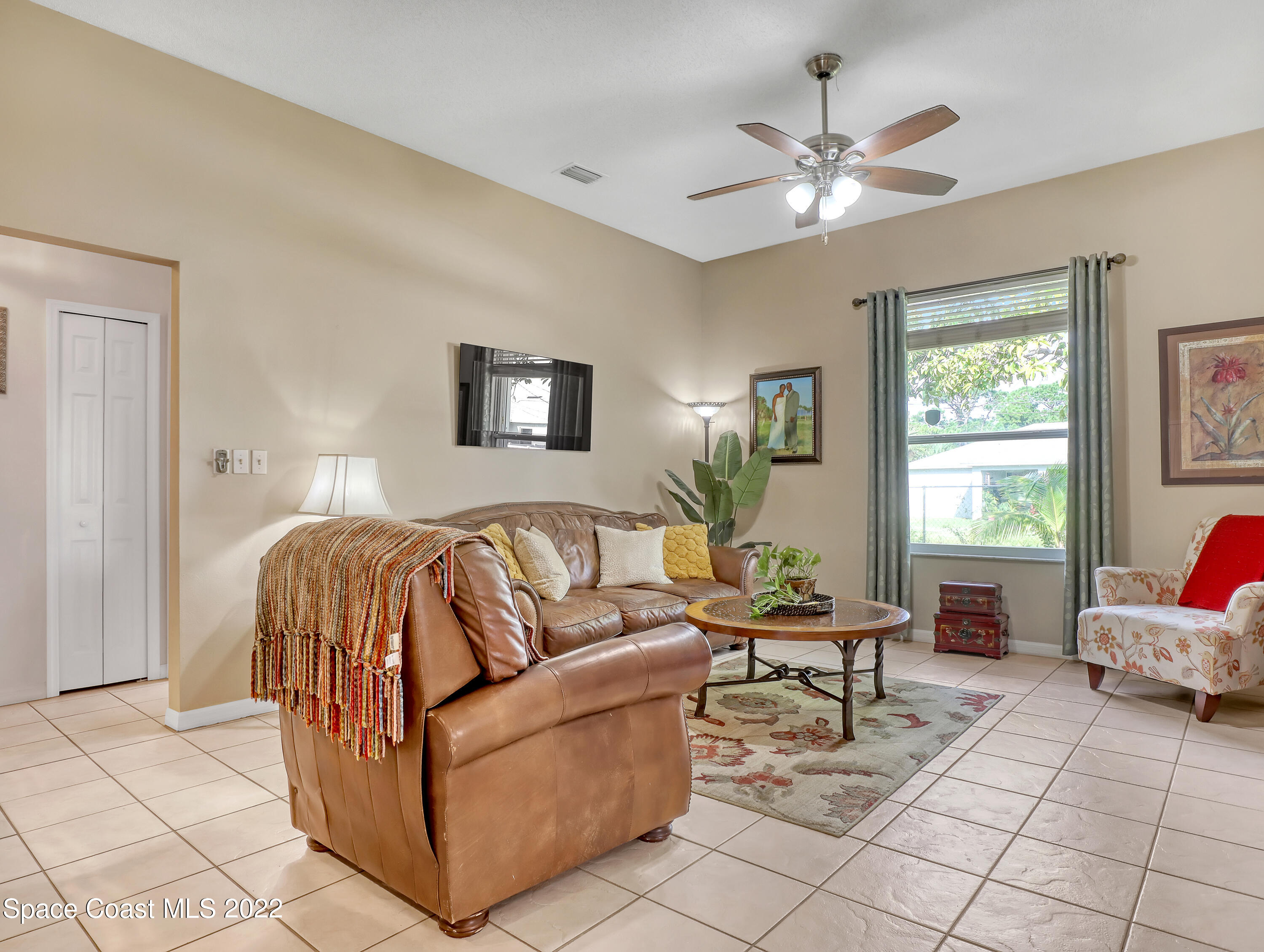 755 Raleigh Road Southeast Palm Bay, FL 32909 - Photo 19 of 36 a living room with furniture and a ceiling fan