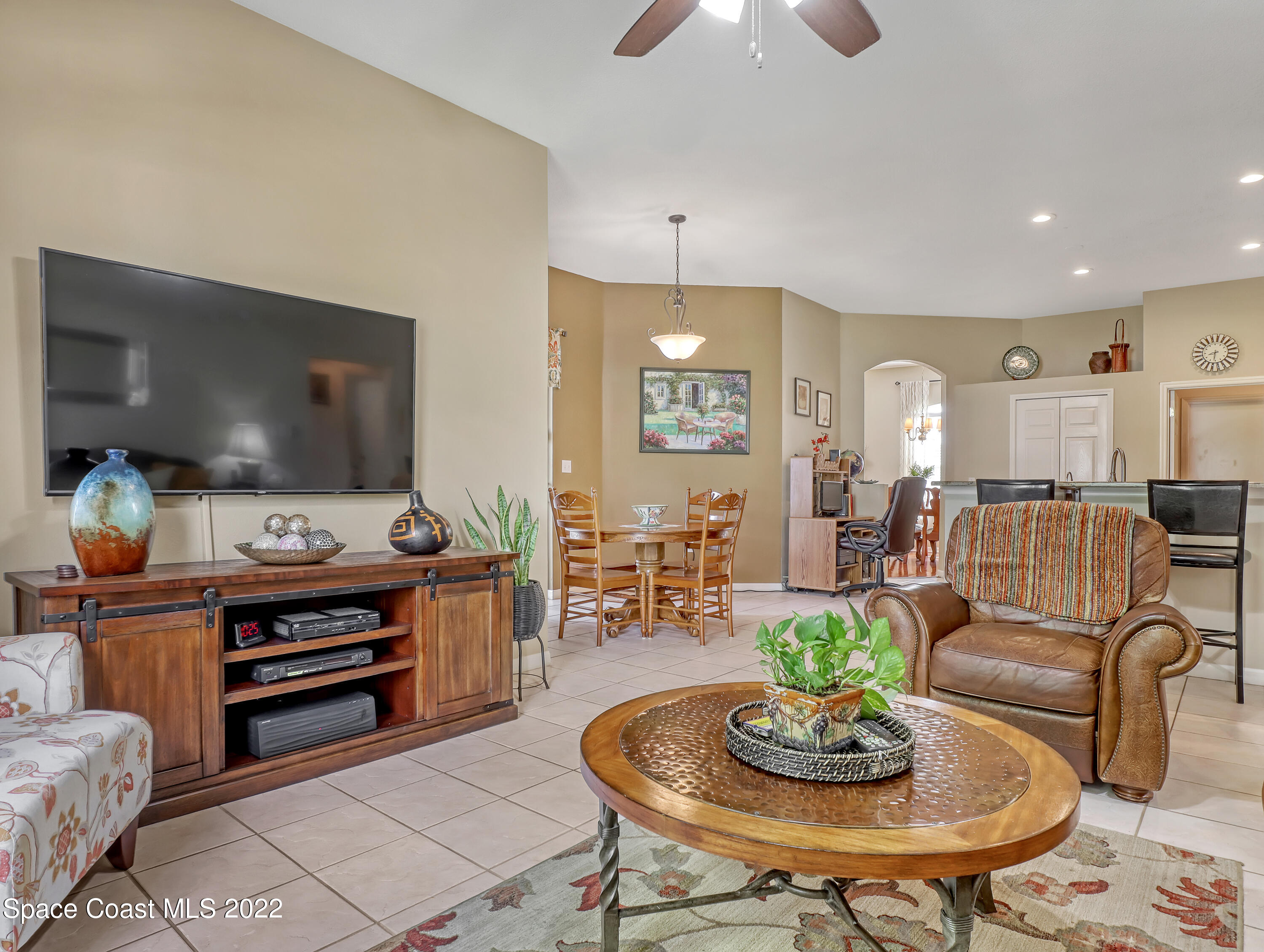 755 Raleigh Road Southeast Palm Bay, FL 32909 - Photo 20 of 36 a living room with furniture and a flat screen tv