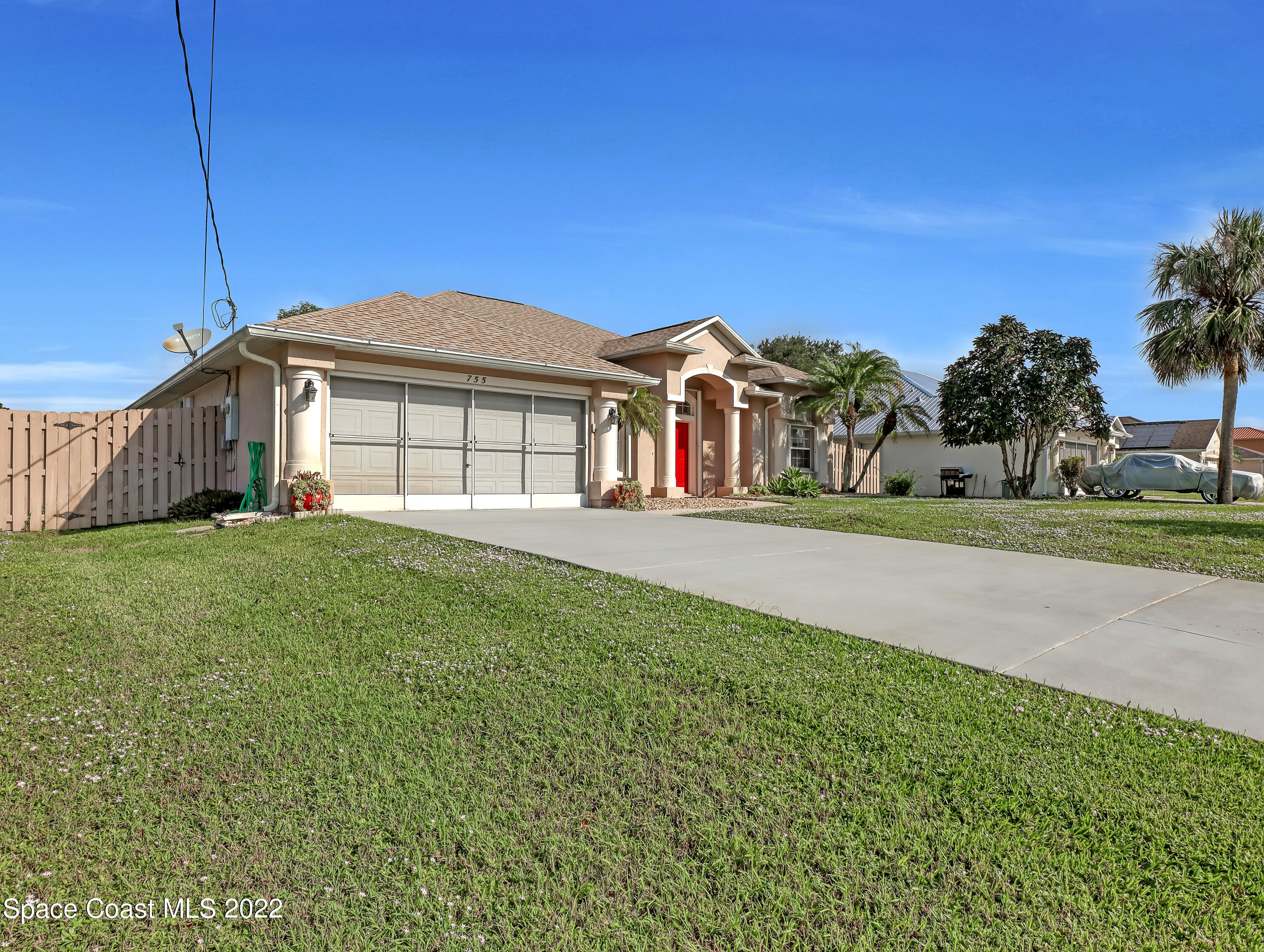 755 Raleigh Road Southeast Palm Bay, FL 32909 - Photo 2 of 36 a front view of a house with a garden