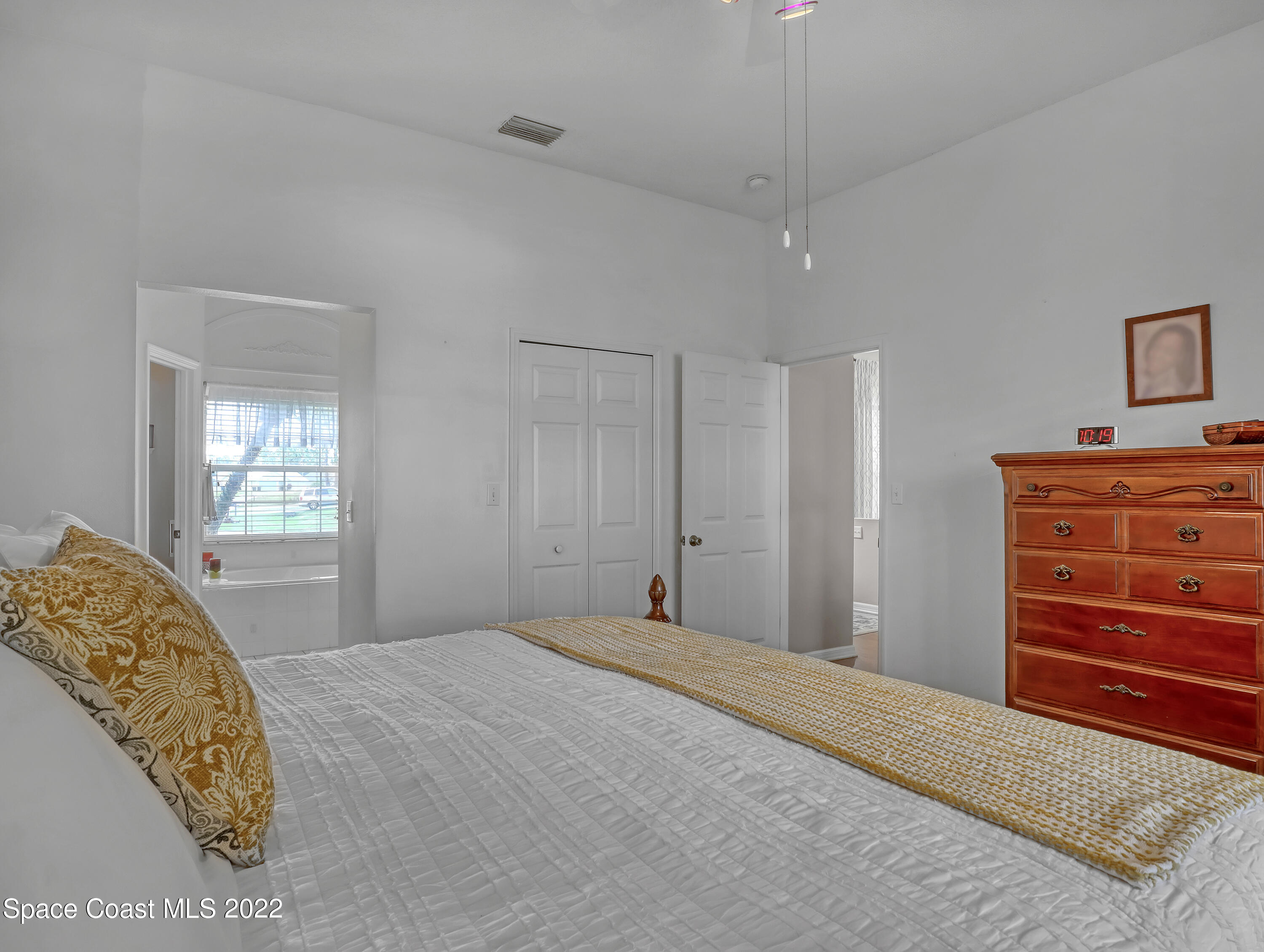 755 Raleigh Road Southeast Palm Bay, FL 32909 - Photo 22 of 36 a bedroom with a bed and a dresser