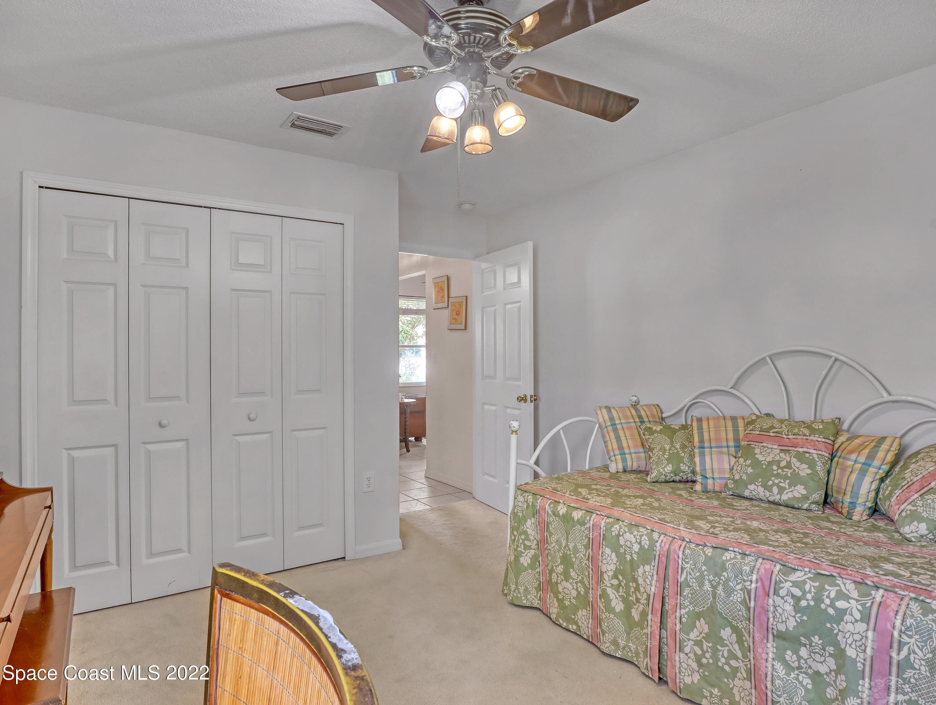 755 Raleigh Road Southeast Palm Bay, FL 32909 - Photo 26 of 36 a bedroom with a bed and a chandelier