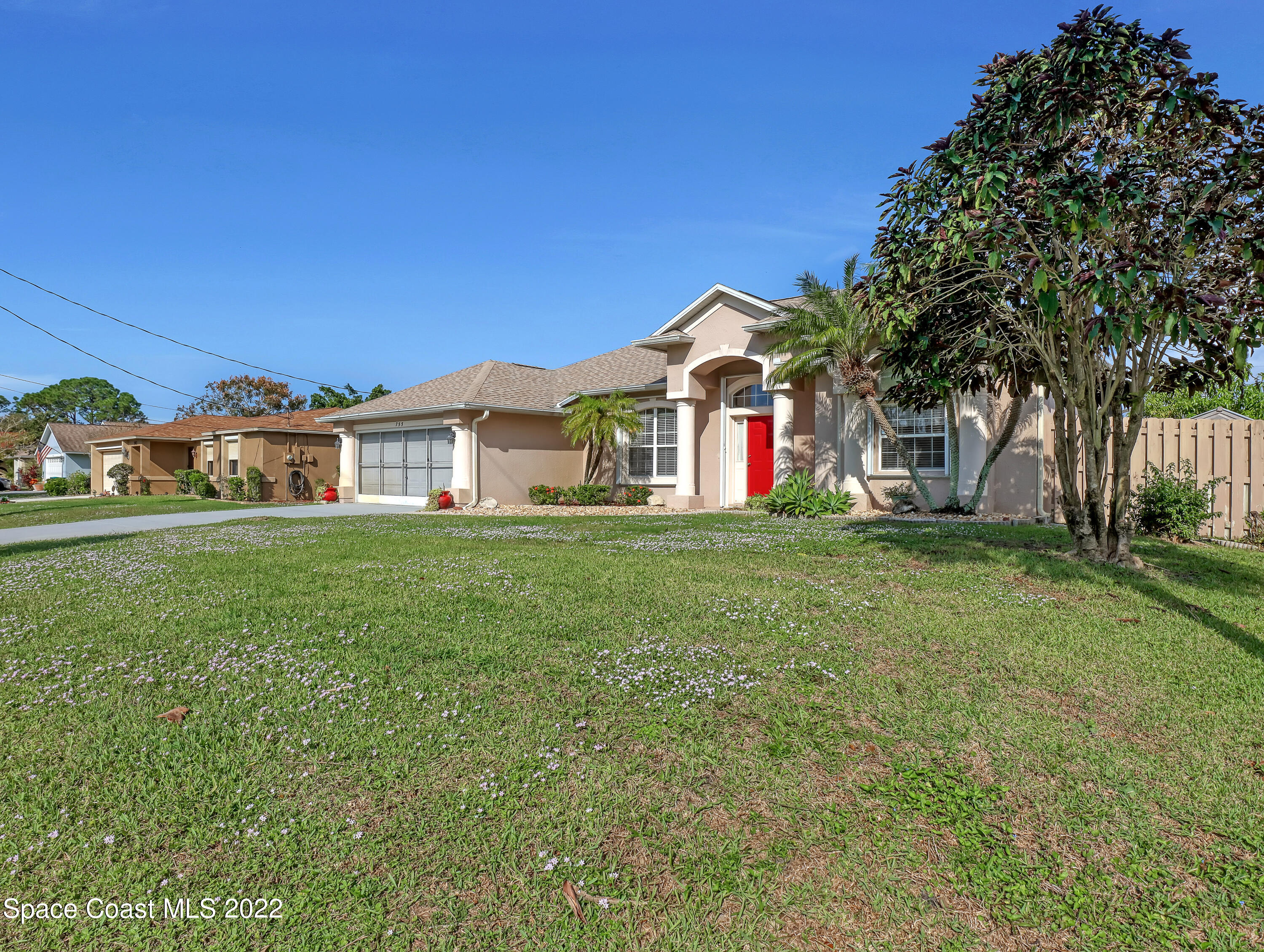 755 Raleigh Road Southeast Palm Bay, FL 32909 - Photo 3 of 36 a front view of house with yard and green space