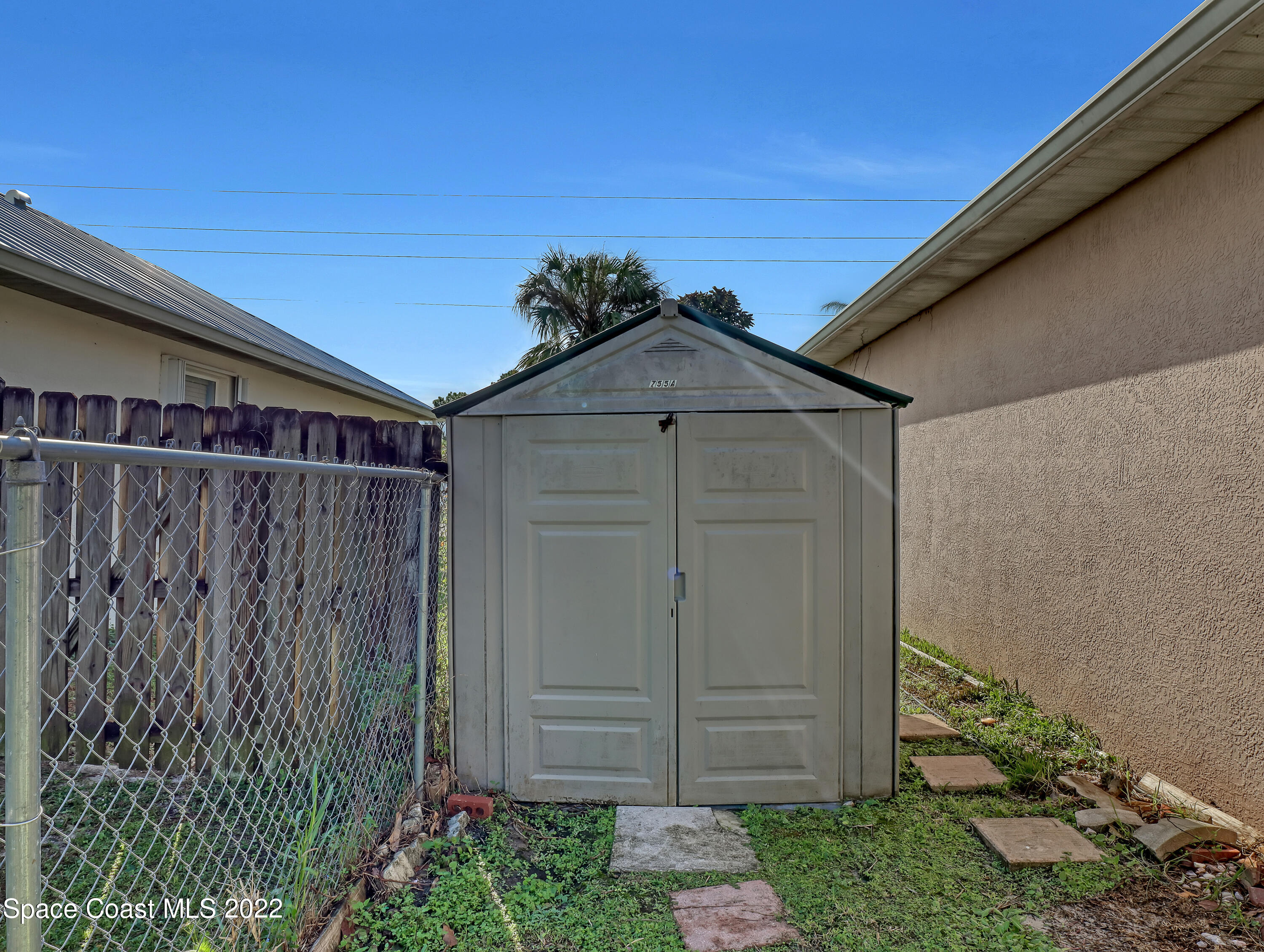 755 Raleigh Road Southeast Palm Bay, FL 32909 - Photo 33 of 36 a wooden door in front of a house