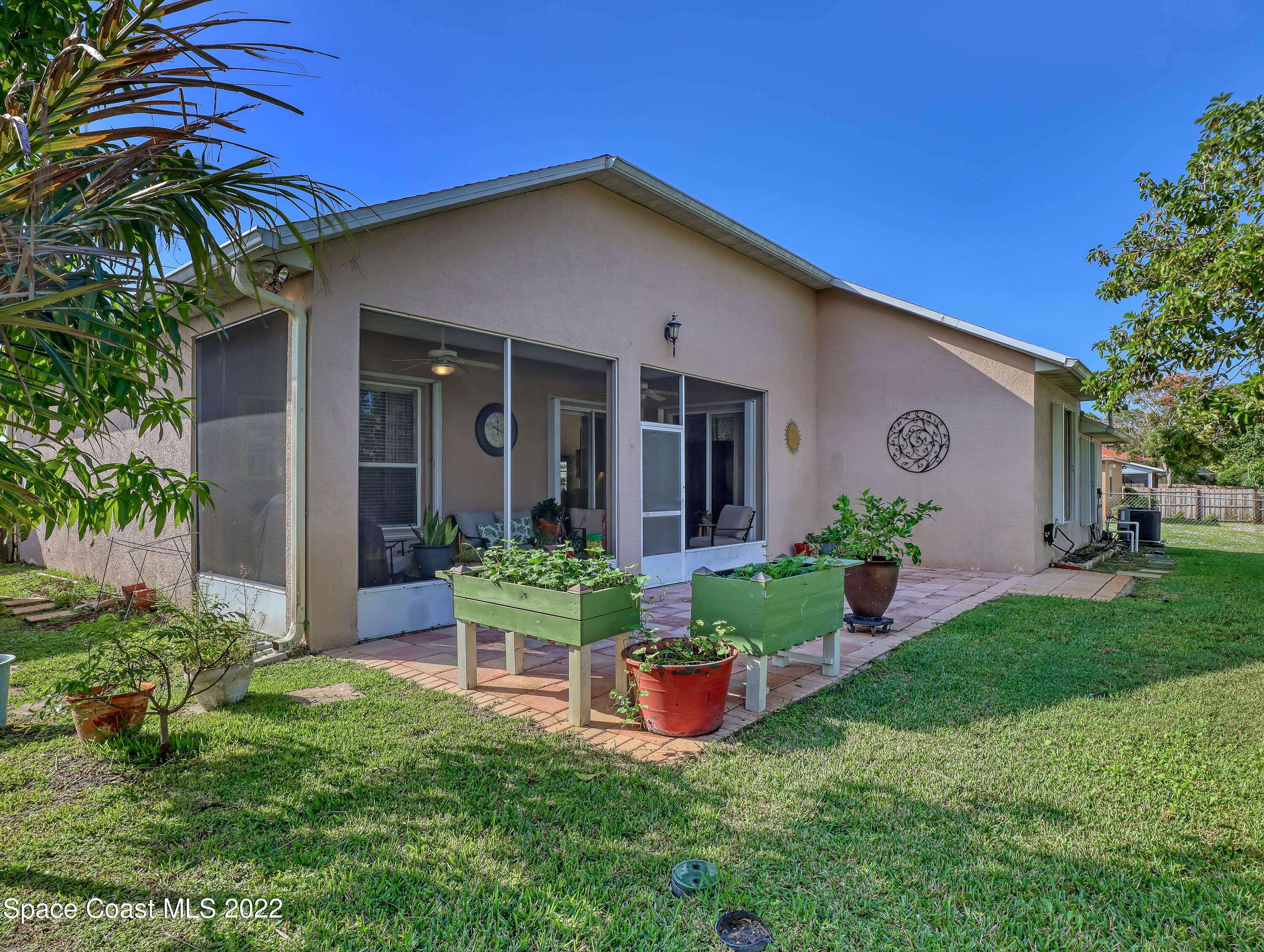 755 Raleigh Road Southeast Palm Bay, FL 32909 - Photo 35 of 36 a front view of house with yard and green space