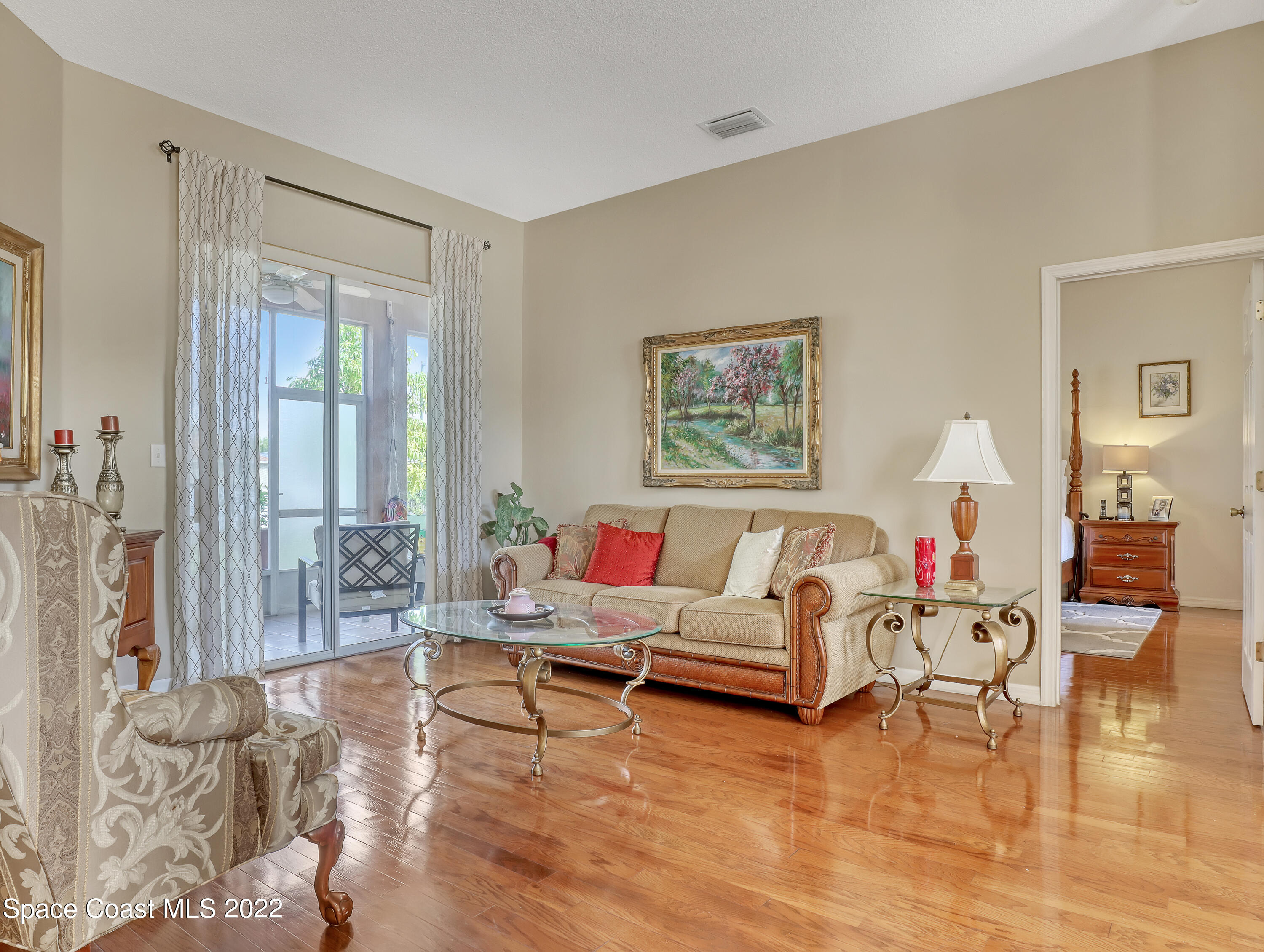 755 Raleigh Road Southeast Palm Bay, FL 32909 - Photo 6 of 36 a living room with furniture and wooden floor