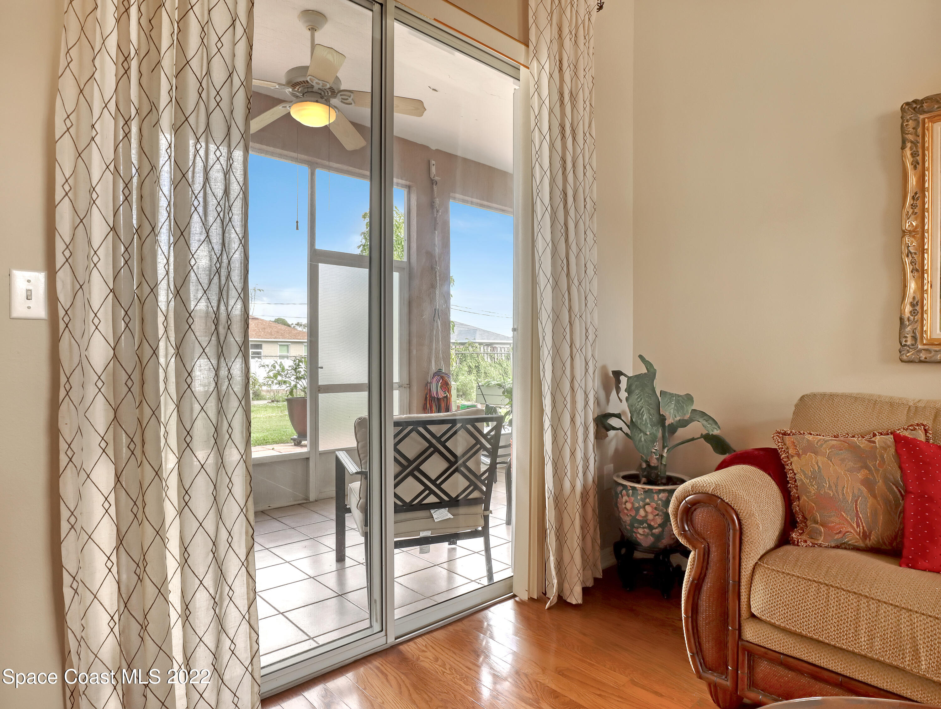 755 Raleigh Road Southeast Palm Bay, FL 32909 - Photo 7 of 36 a living room with furniture and a floor to ceiling window