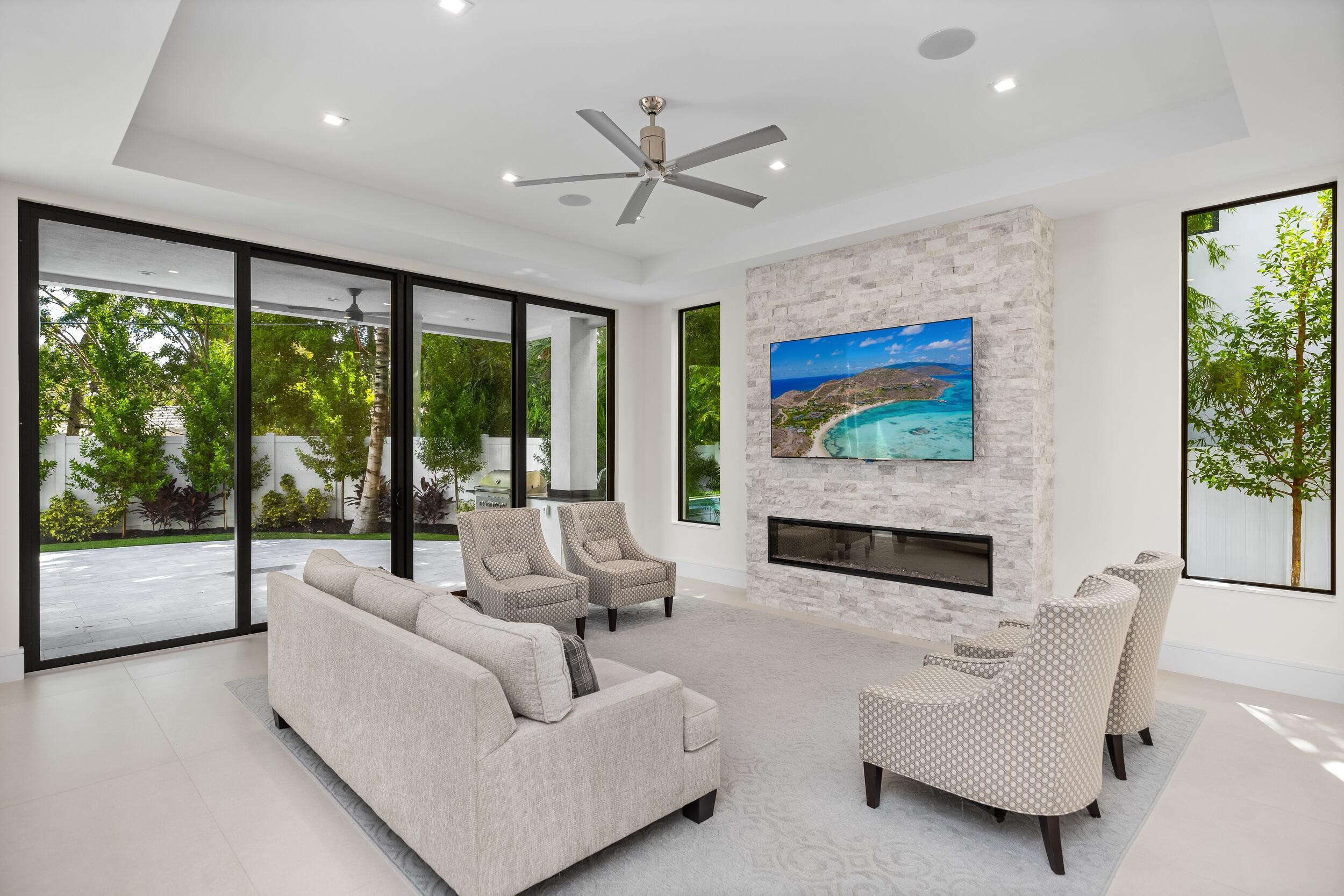 753 Park Drive West Boca Raton, FL 33432 - Photo 23 of 50 a living room with furniture large windows and a flat screen tv