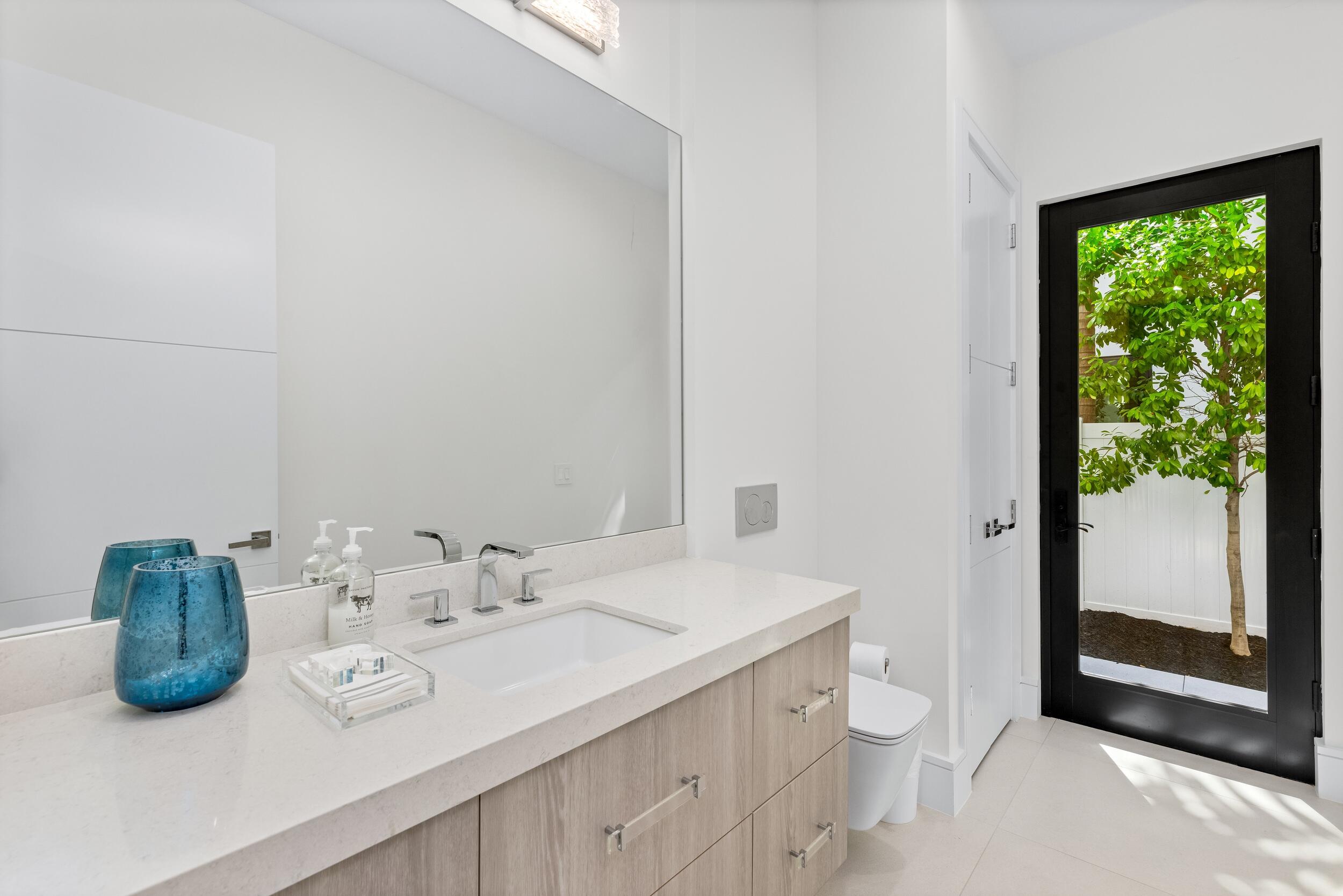 753 Park Drive West Boca Raton, FL 33432 - Photo 25 of 50 a bathroom with a granite countertop sink and a mirror