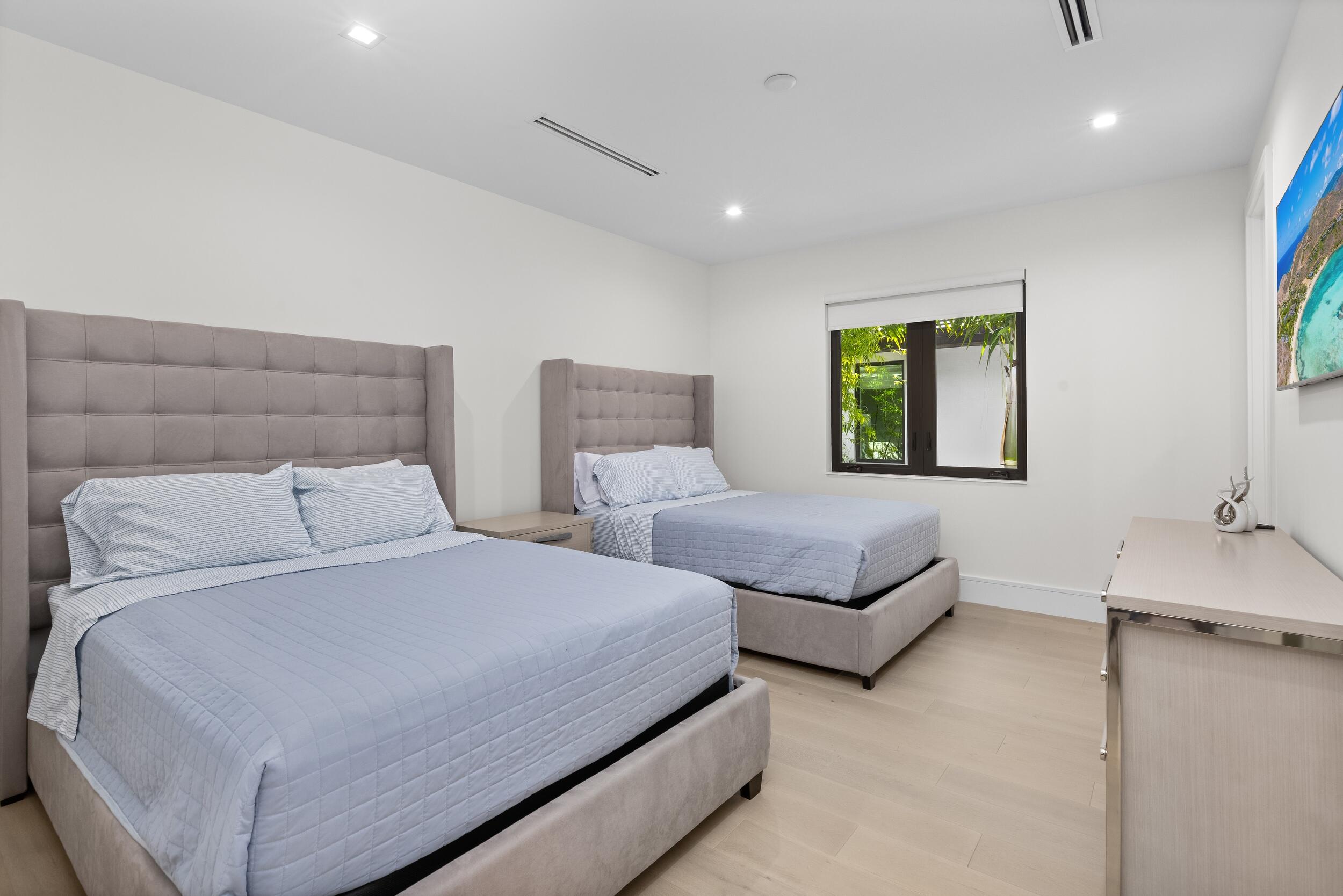 753 Park Drive West Boca Raton, FL 33432 - Photo 43 of 50 a bedroom with two beds and painting on the wall