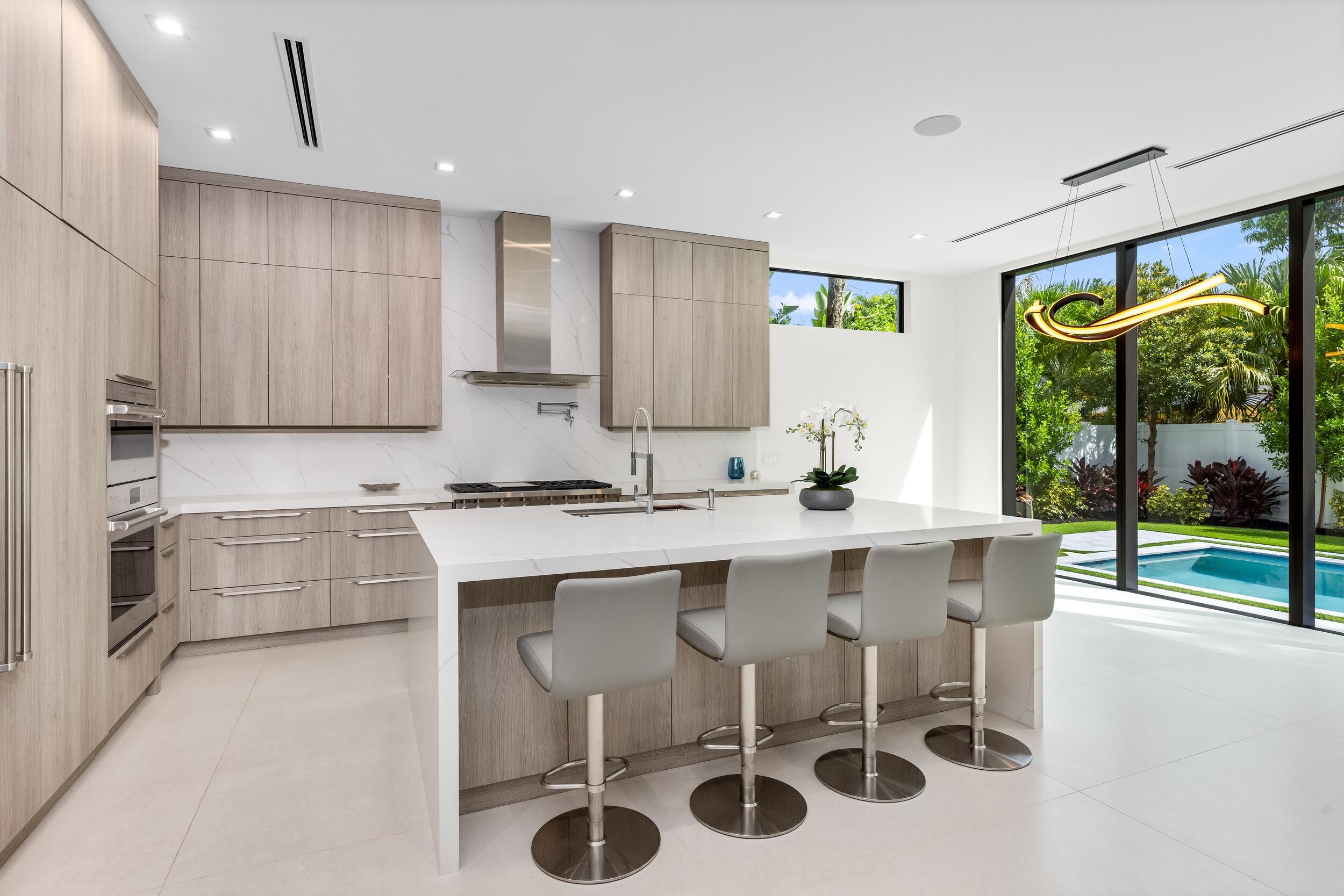 753 Park Drive West Boca Raton, FL 33432 - Photo 5 of 50 a kitchen with a sink and chairs
