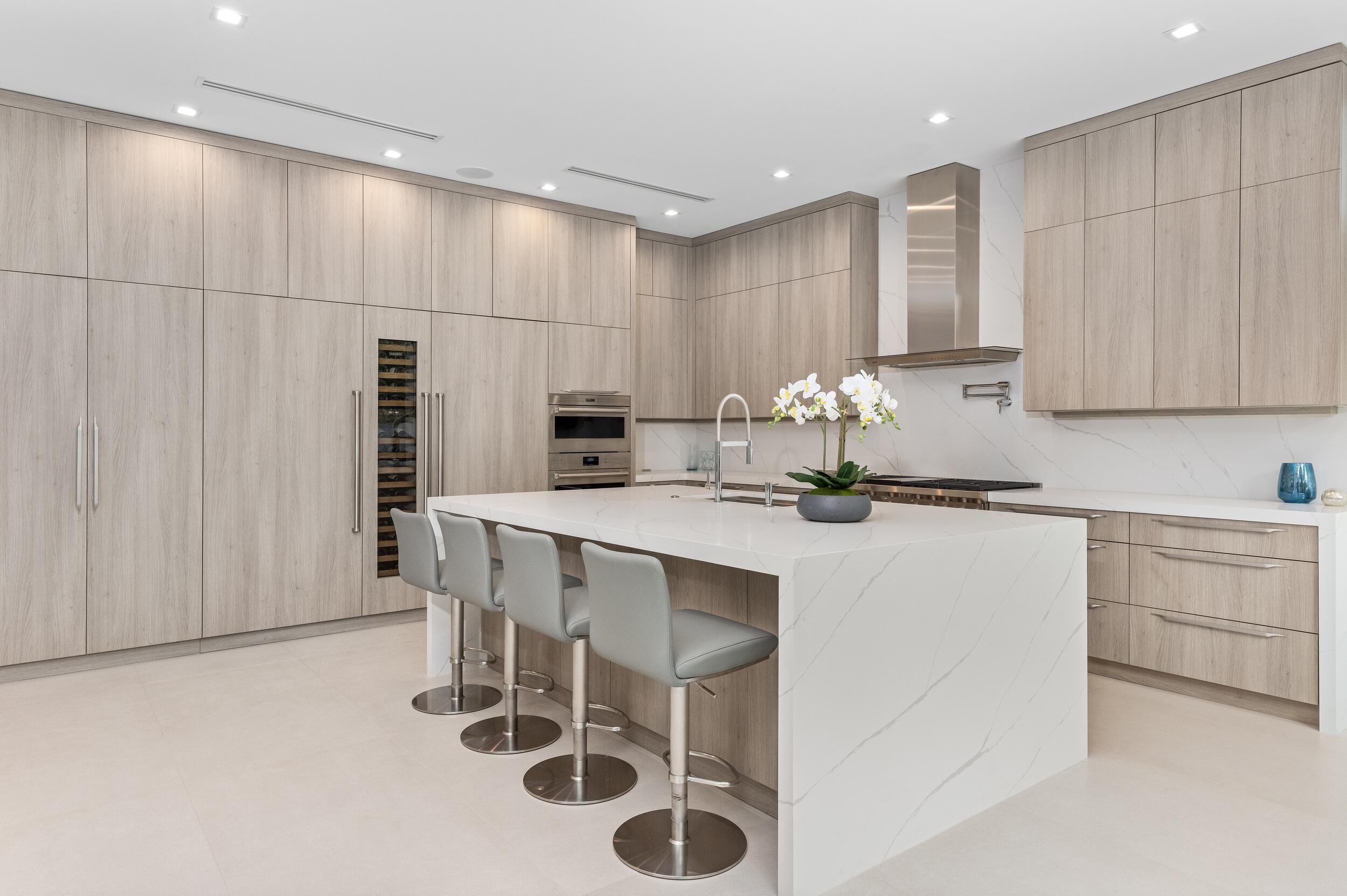 753 Park Drive West Boca Raton, FL 33432 - Photo 6 of 50 a kitchen with stainless steel appliances kitchen island granite countertop a table chairs sink and cabinets