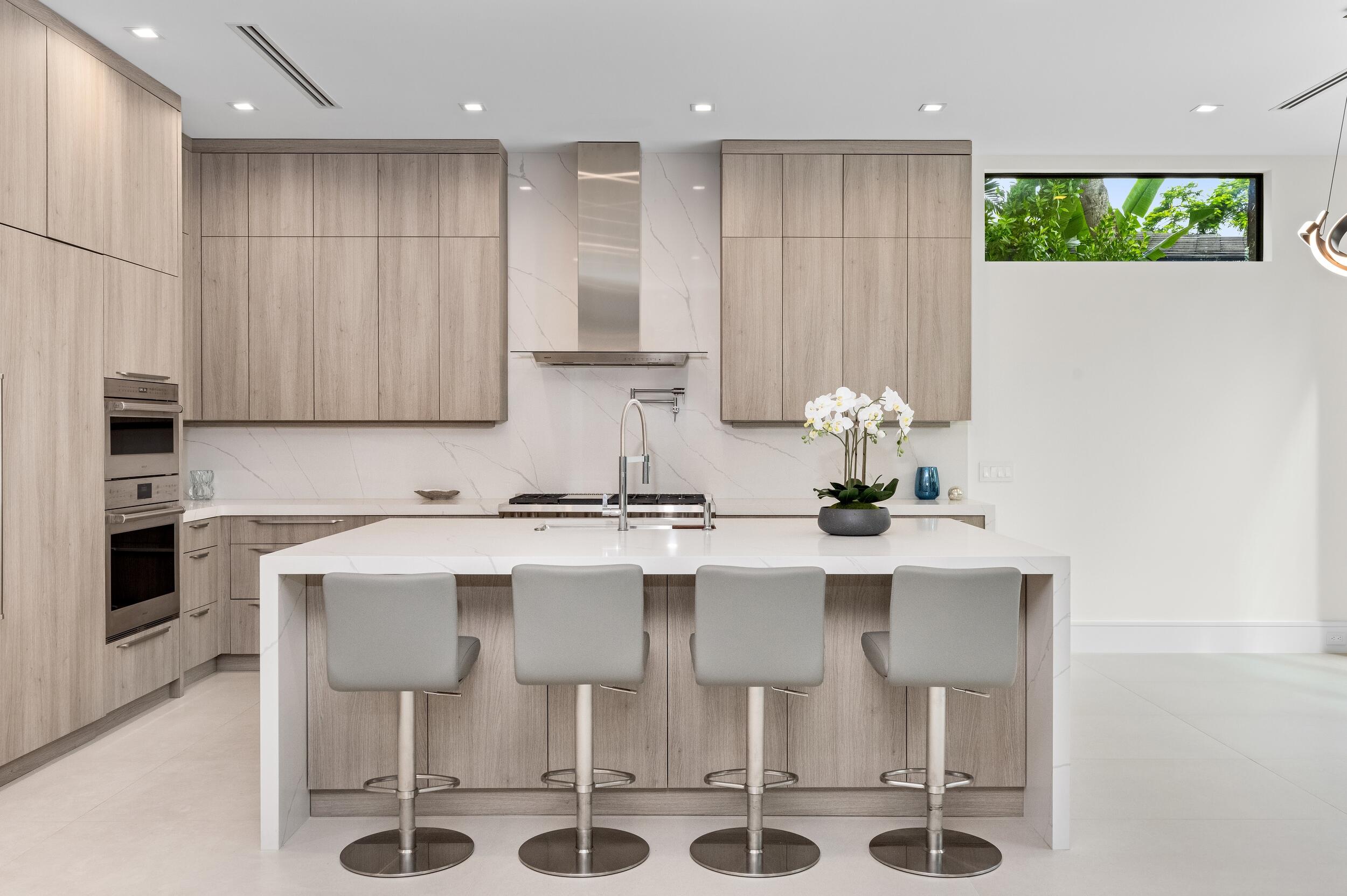 753 Park Drive West Boca Raton, FL 33432 - Photo 7 of 50 a kitchen with stainless steel appliances kitchen island granite countertop a sink and cabinets