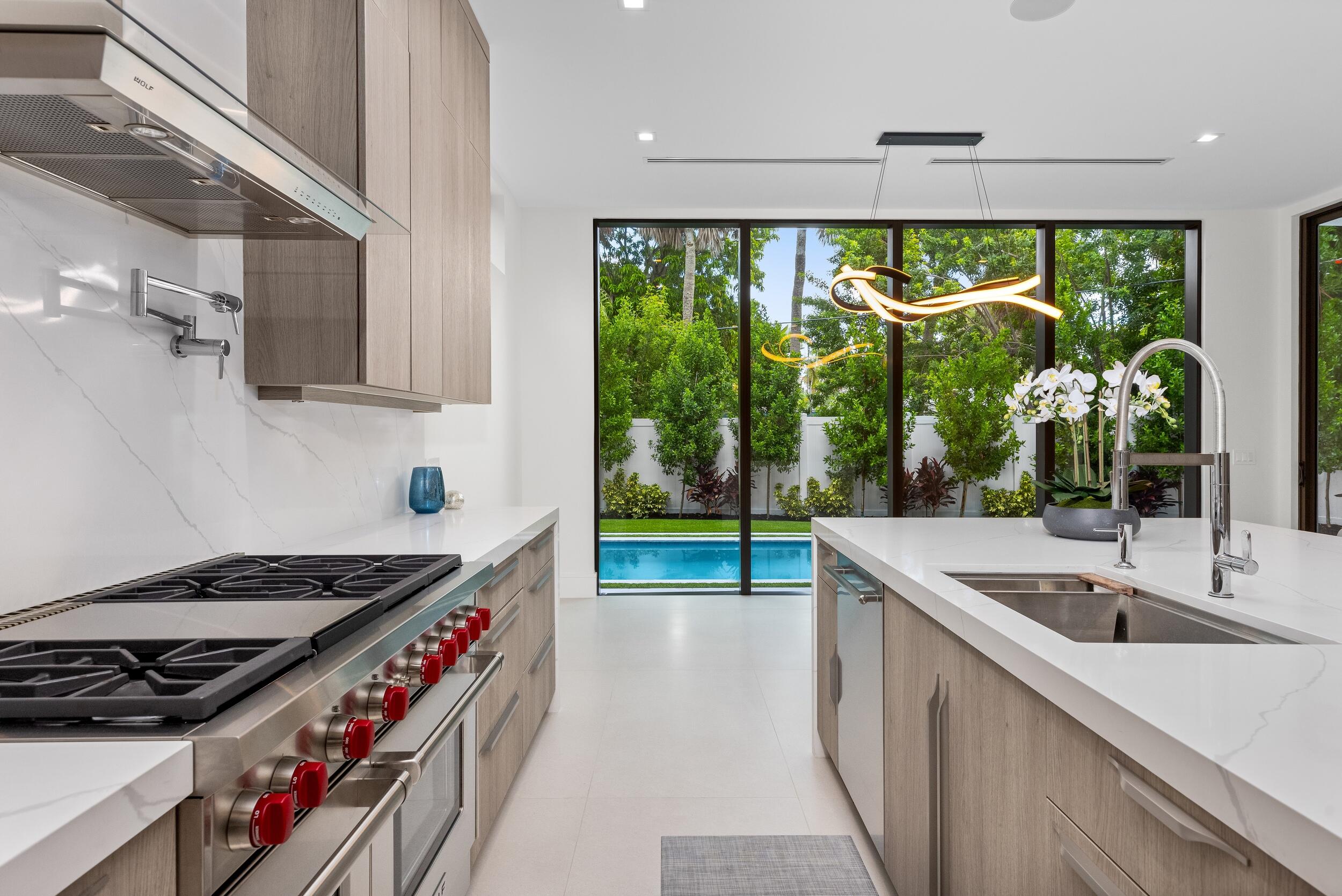 753 Park Drive West Boca Raton, FL 33432 - Photo 9 of 50 a kitchen that has a lot of fruit on it and wooden floor