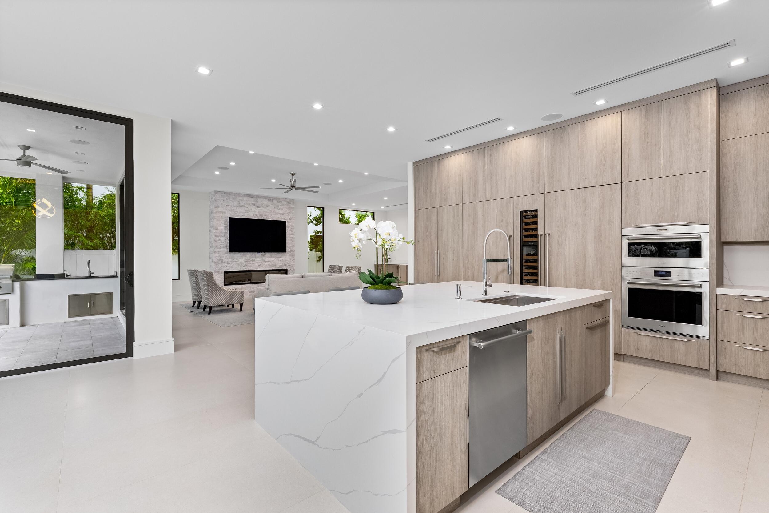 753 Park Drive West Boca Raton, FL 33432 - Photo 10 of 50 a kitchen with stainless steel appliances kitchen island granite countertop a stove and a refrigerator